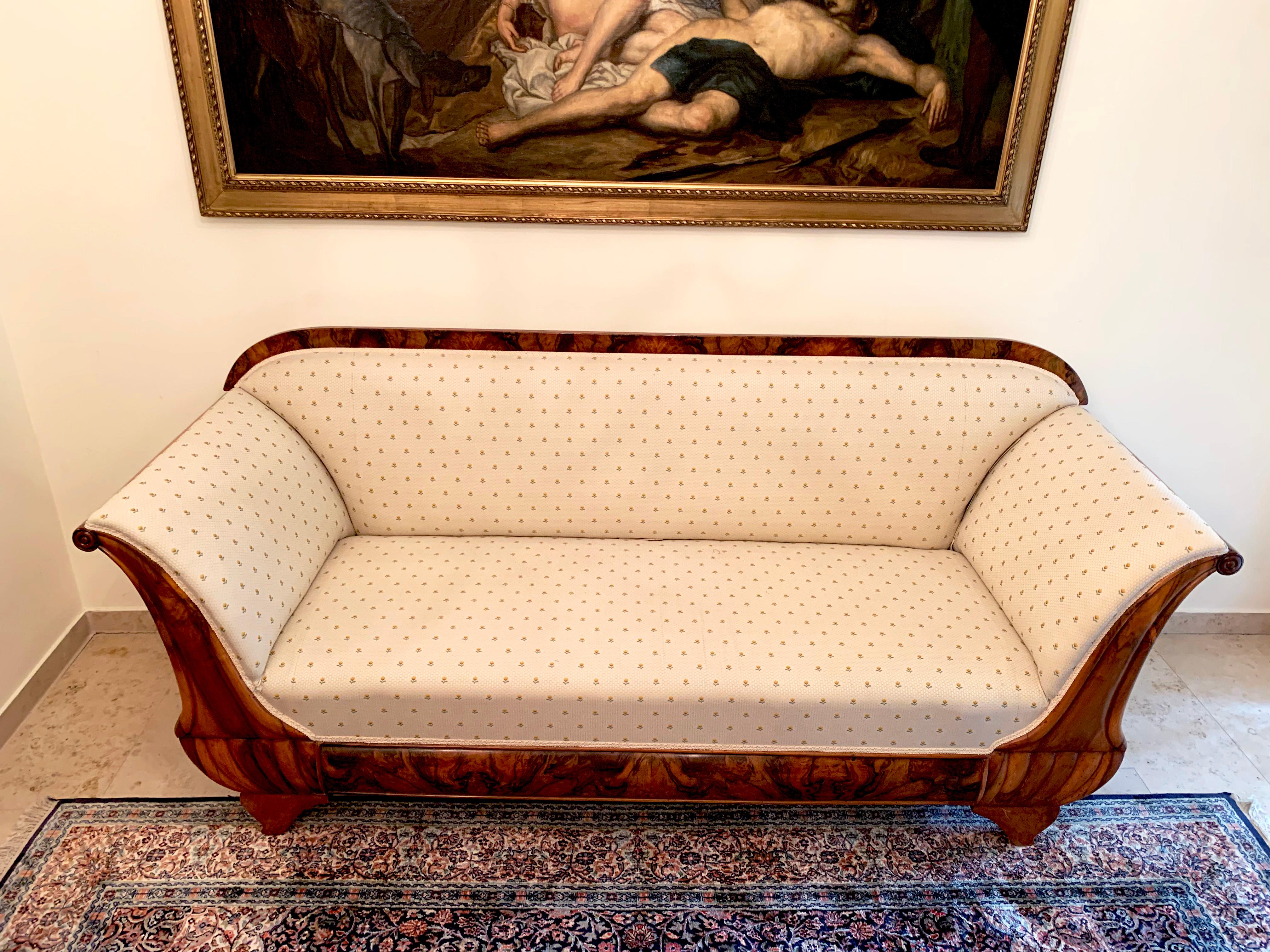 Large Biedermeier sofa circa 1830 in a typical cream material with yellow flowers.
This beautiful cream sofa is made out of walnut. It is an elegant piece.
The Biedermeier period refers to an era in Central Europe between 1815 and 1848, during