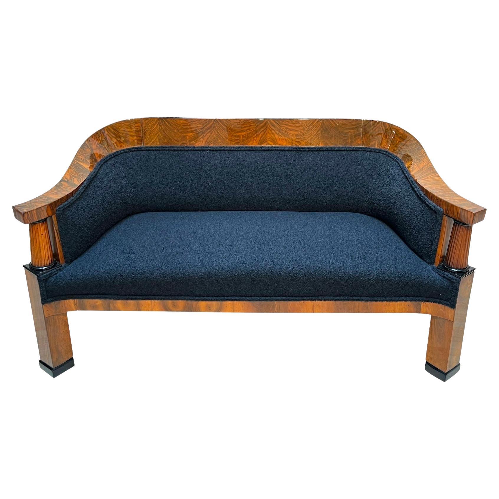 Beautiful neoclassical Biedermeier Sofa from Vienna, Austria circa 1825.
Walnut veneered and solid walnut. Two fluted full columns in beech with ebonized capitals and bases.Newly covered with black teddy (Bouclé) fabric and double keder. The