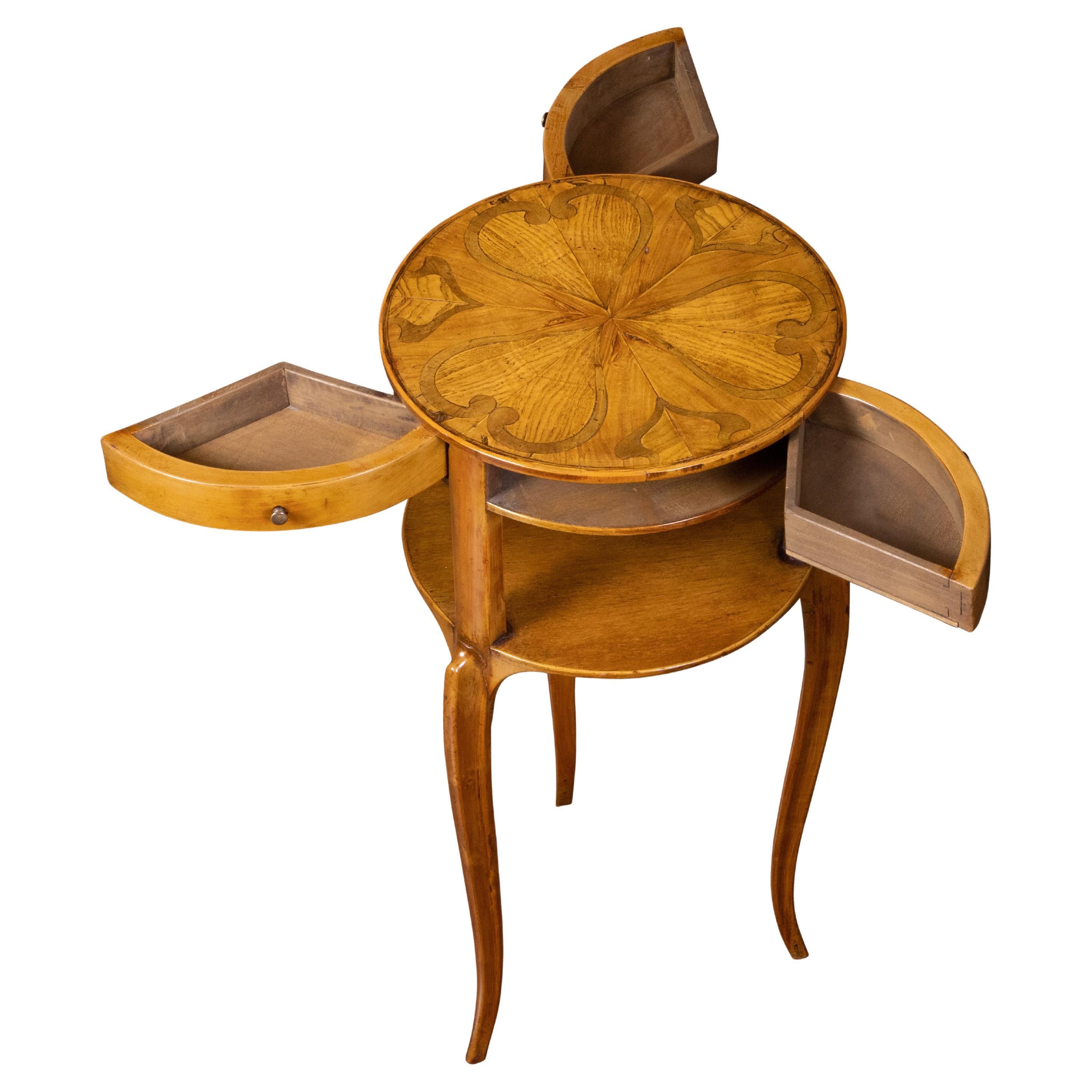 An Austrian Biedermeier style side table from the late 19th century, with marquetry top and sliding drawers. Created during the later years of the 19th century, this Biedermeier style table features a circular top with heart-shaped marquetry,