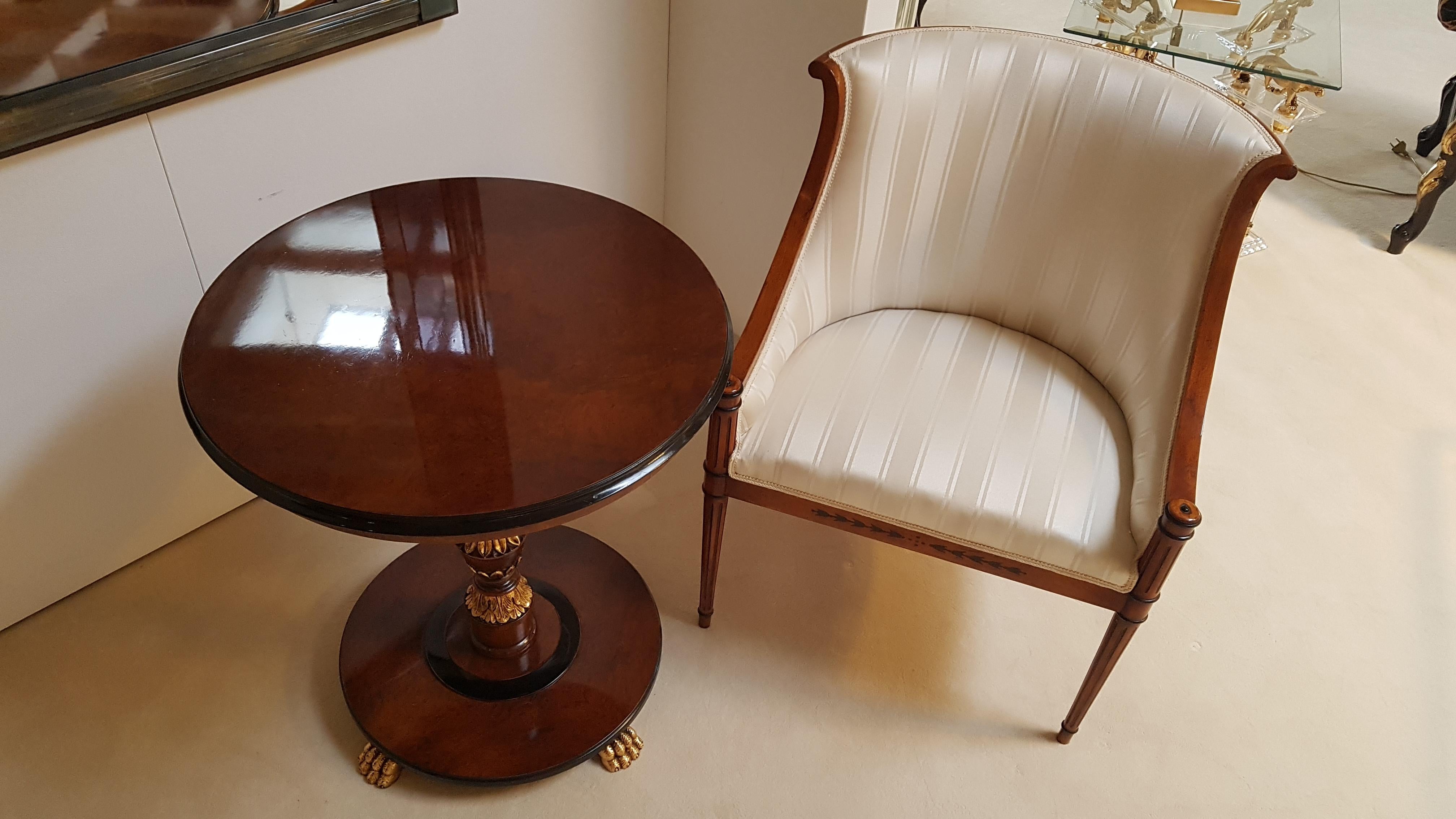 Elegant Biedermeier style armchair and side table / end table set made of luxurious cherry wood. The armchair with curved legs is covered with a two tone crème white fabric and features a typical Biedermeier style design. On the side table you will