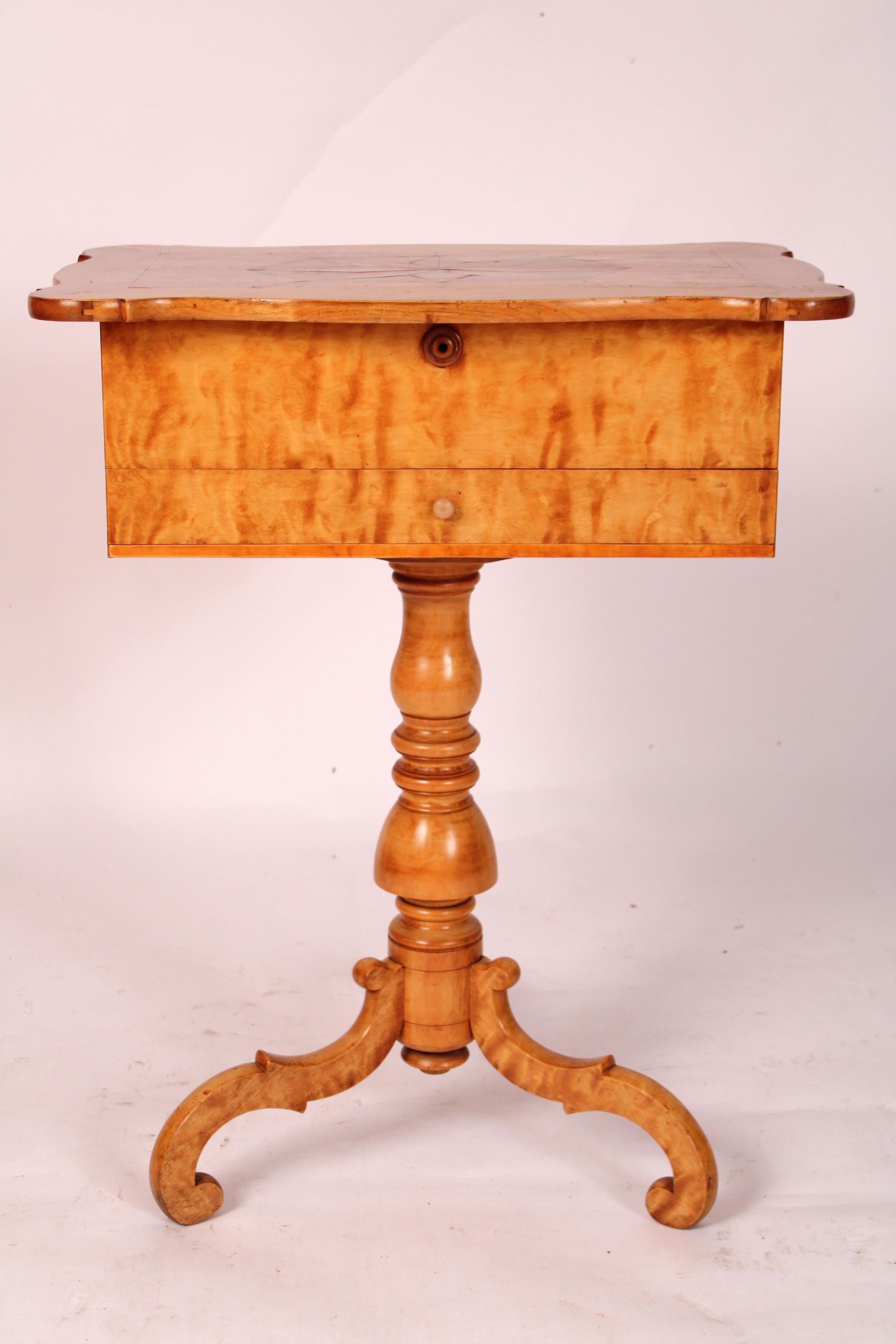 Biedermeier style birch occasional table with lift top, circa 1950's. The lift up top with serpentine shaped front and side edges, turret corners, central inlay and birds eye birch, the frieze with one hand dove tailed drawer, a baluster shaped