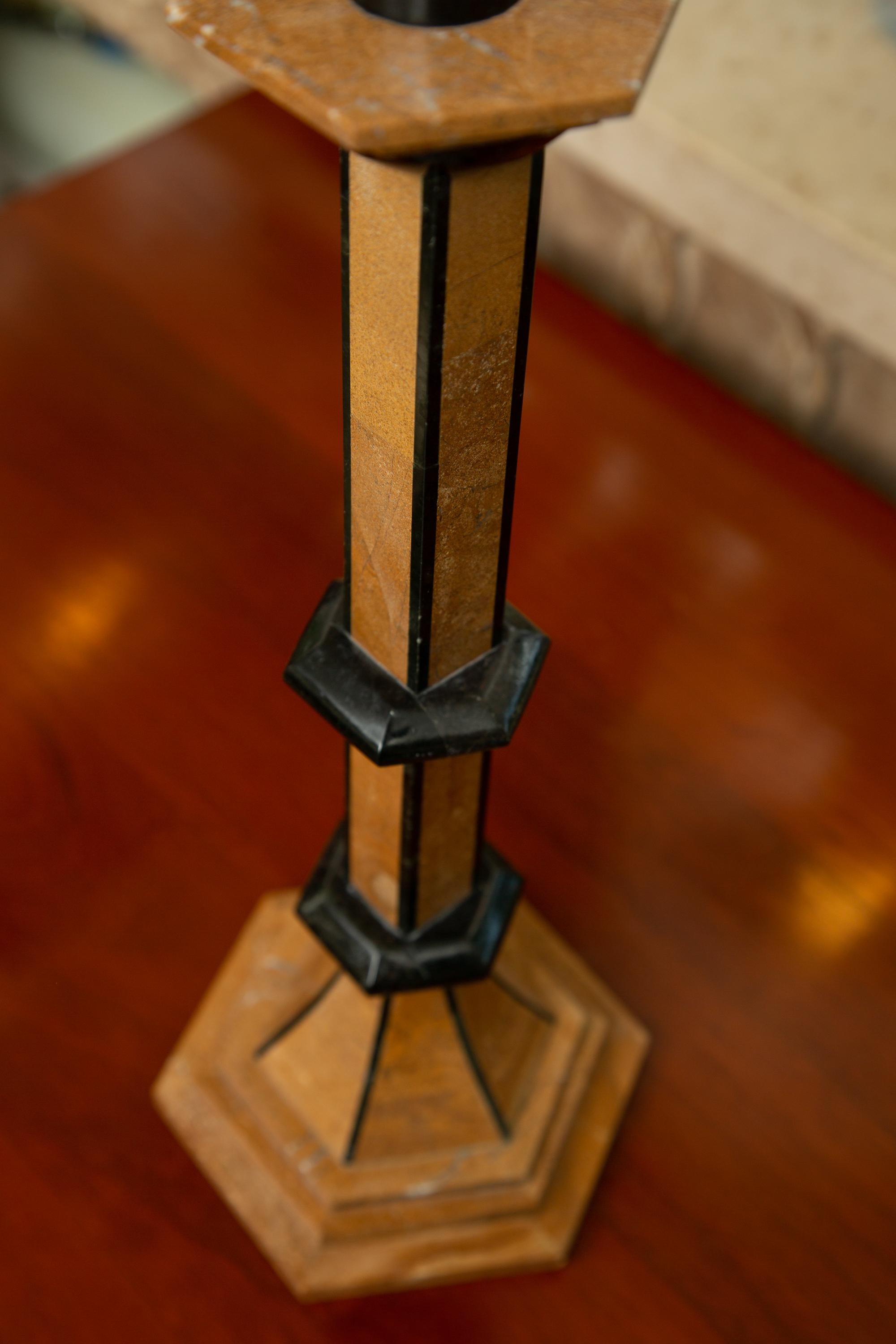 These are an interesting pair of Biedermeier style candlestick holders. They are inlaid with a veneer of stone and are outlined with ebonized decoration, mid-20th century.