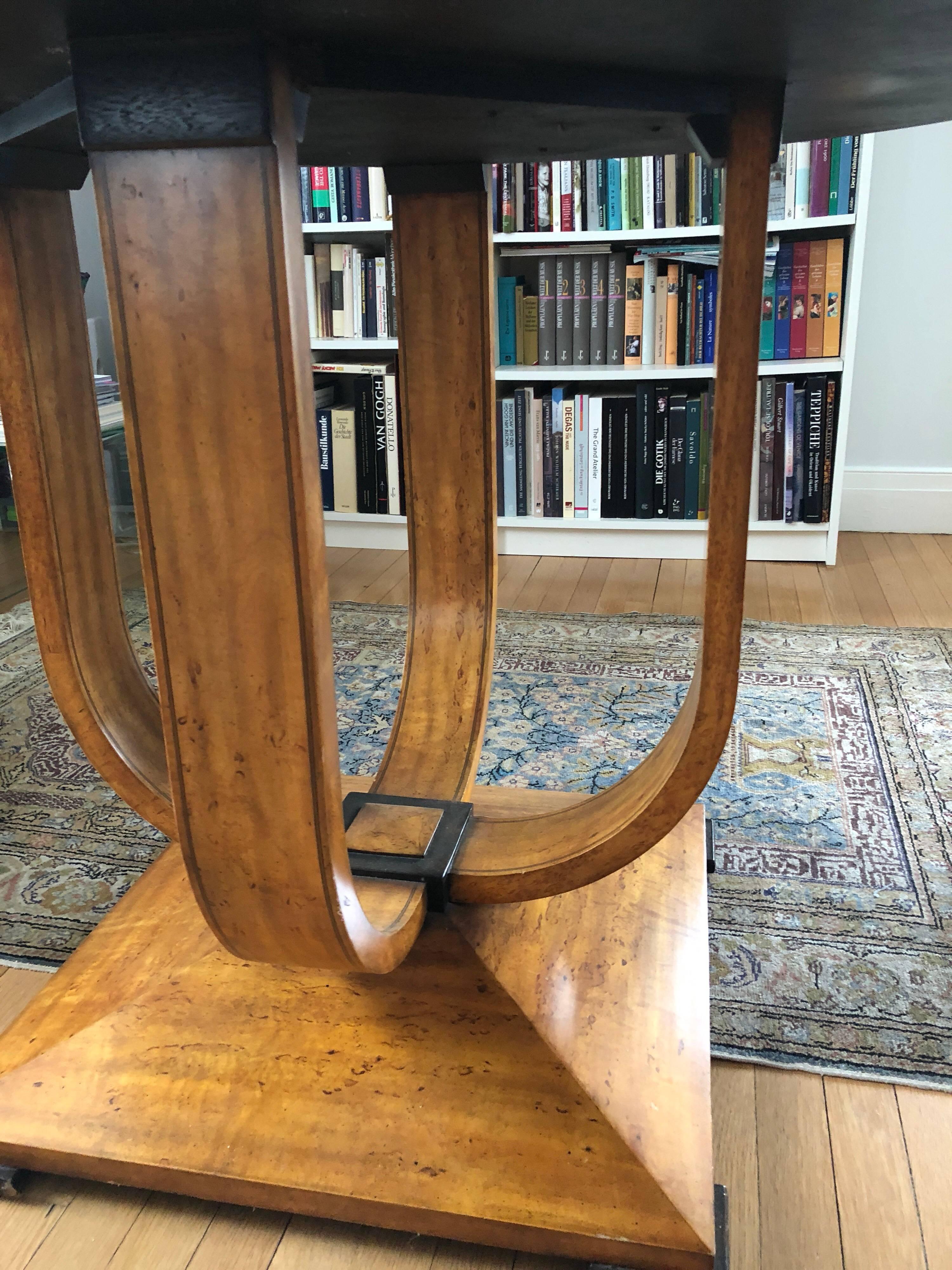 Elegant Biedermeier style center table, 20th century. Birch veneer with ebonized details.
In very good condition.  The table was made by Maitland - Smith.