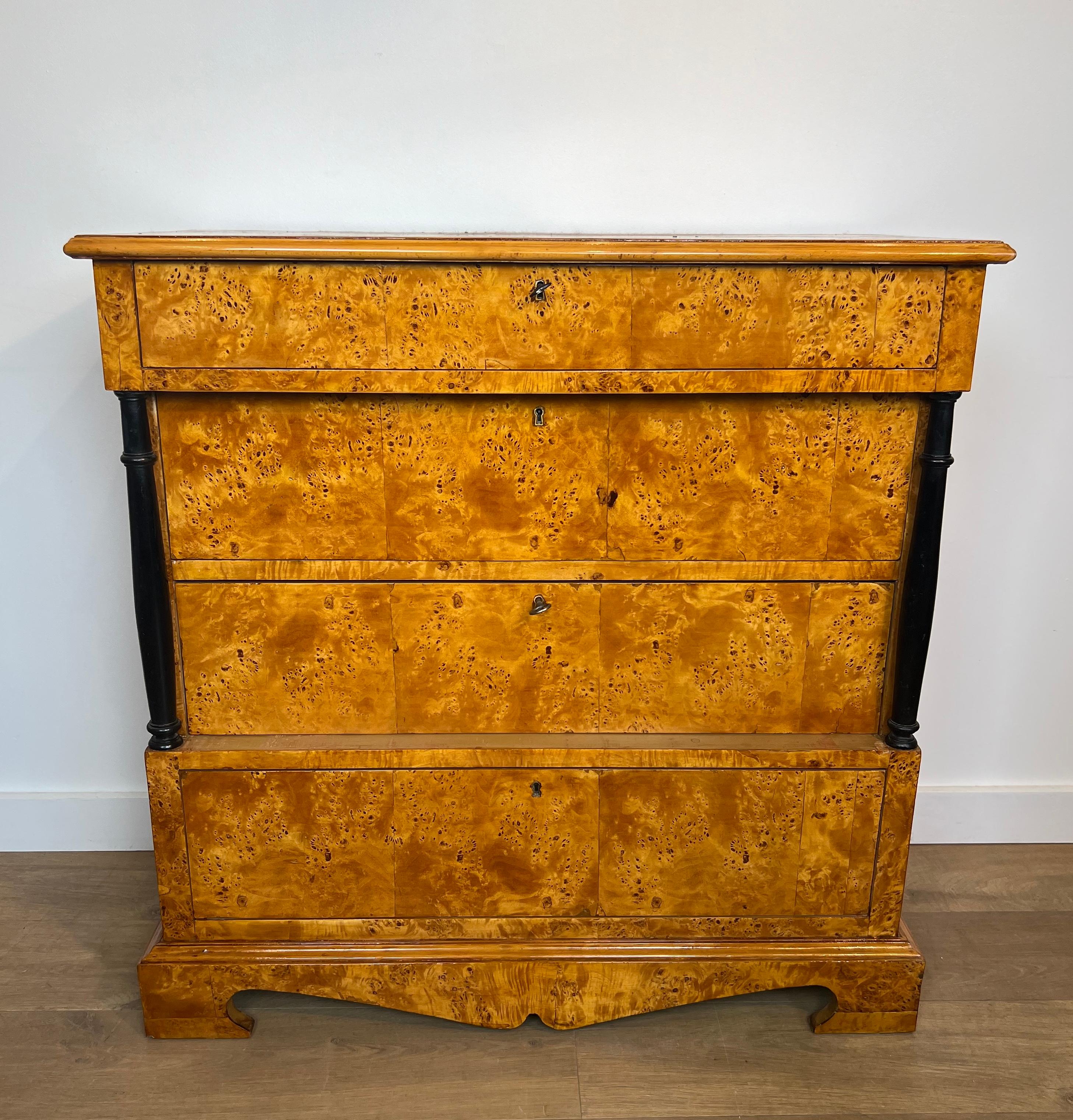 This very elegant chest of drawers with four drawers is made of maple with ebonized columns. This is a German work in the style of Biedermeier. Circa 1950