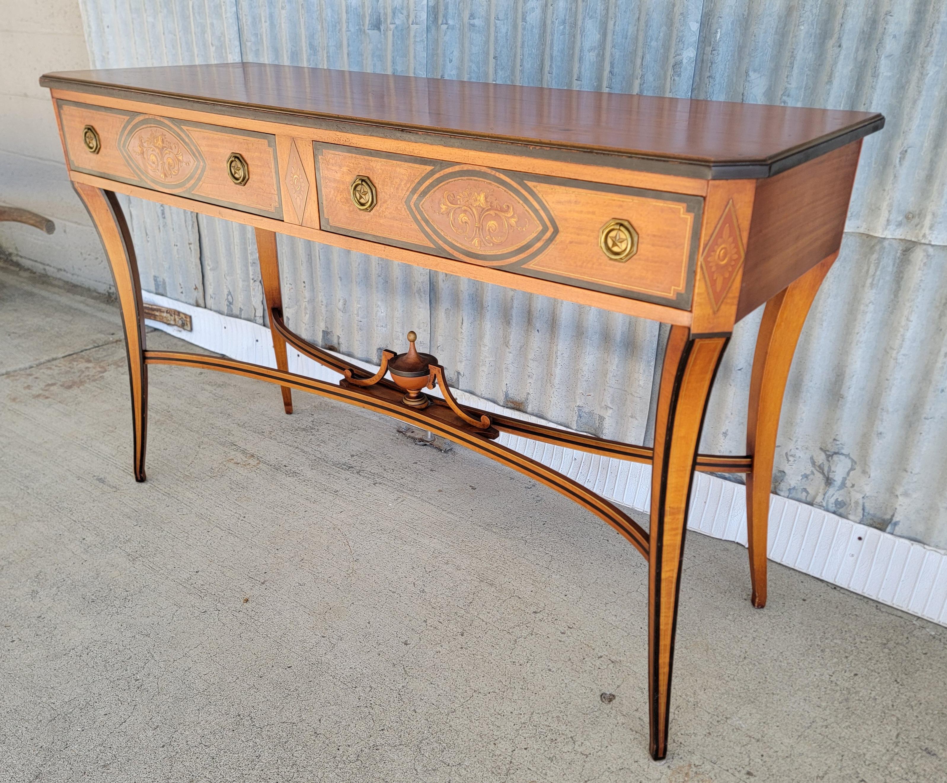 A 1920's Biedermeier style serving table crafted in a beautiful, figured satinwood. Embellished with hand painted details. Retains brass makers mark by Landstrom Furniture, Rockford, Illinois. Original finish to base with Top surface refinished.

54