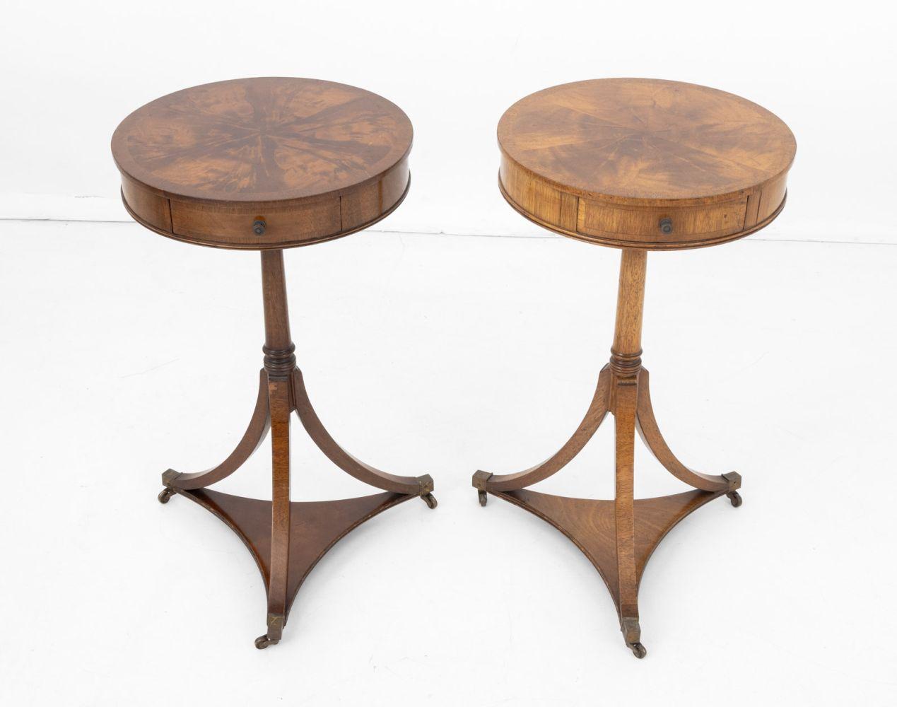 Pair of Biedermeier Style Flame Mahogany Tripod Side Tables, the round tops with single drawers on three legs conjoined by under tier with brass tips and casters. 27