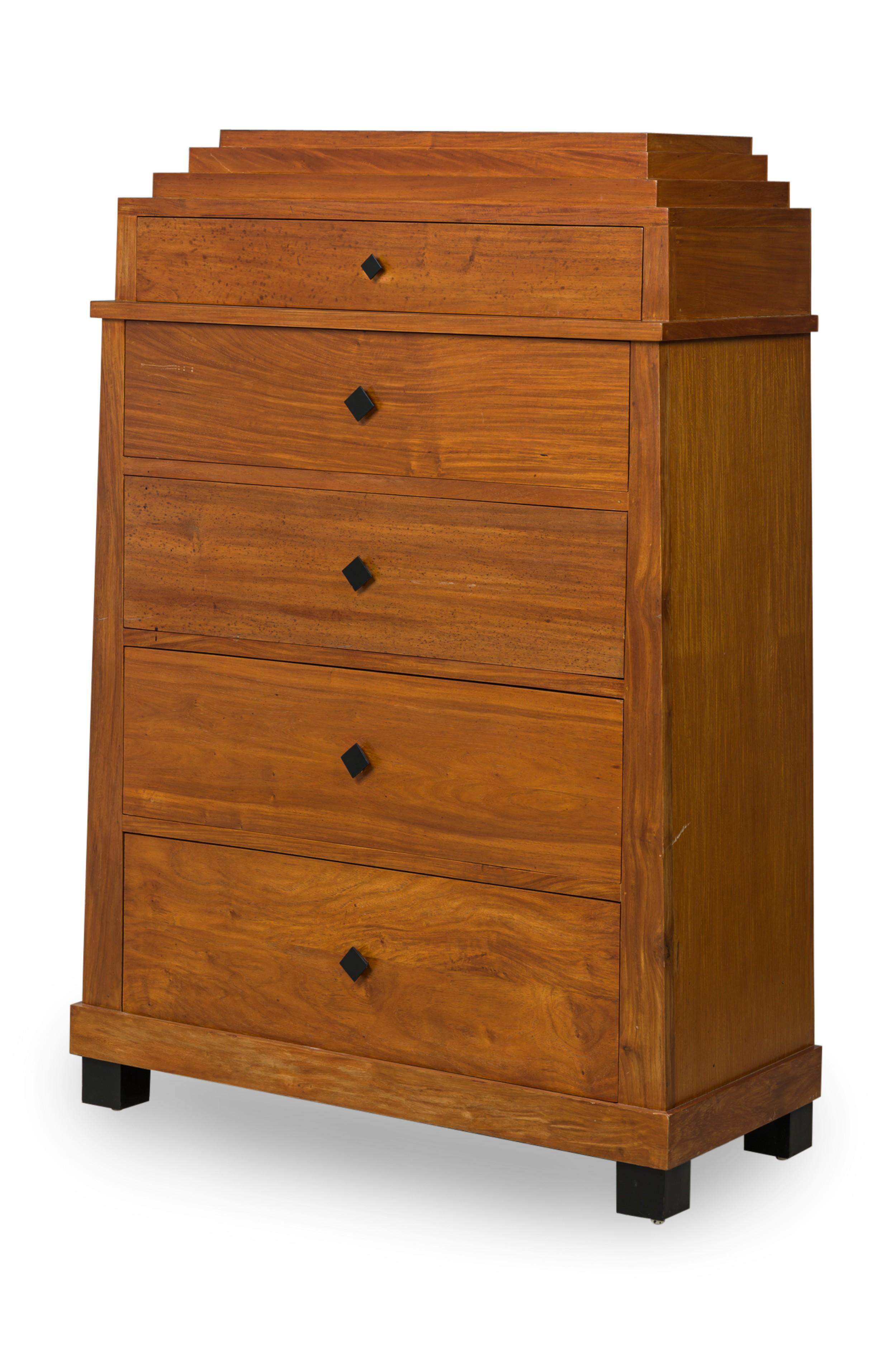 Biedermeier Style 5-drawer wood chest featuring a decorative stepped top with a narrow drawer followed by 4 evenly spaced larger drawers with ebonized diamond shaped pulls and 4 tapered block feet.
 

 Slight wear on corners
