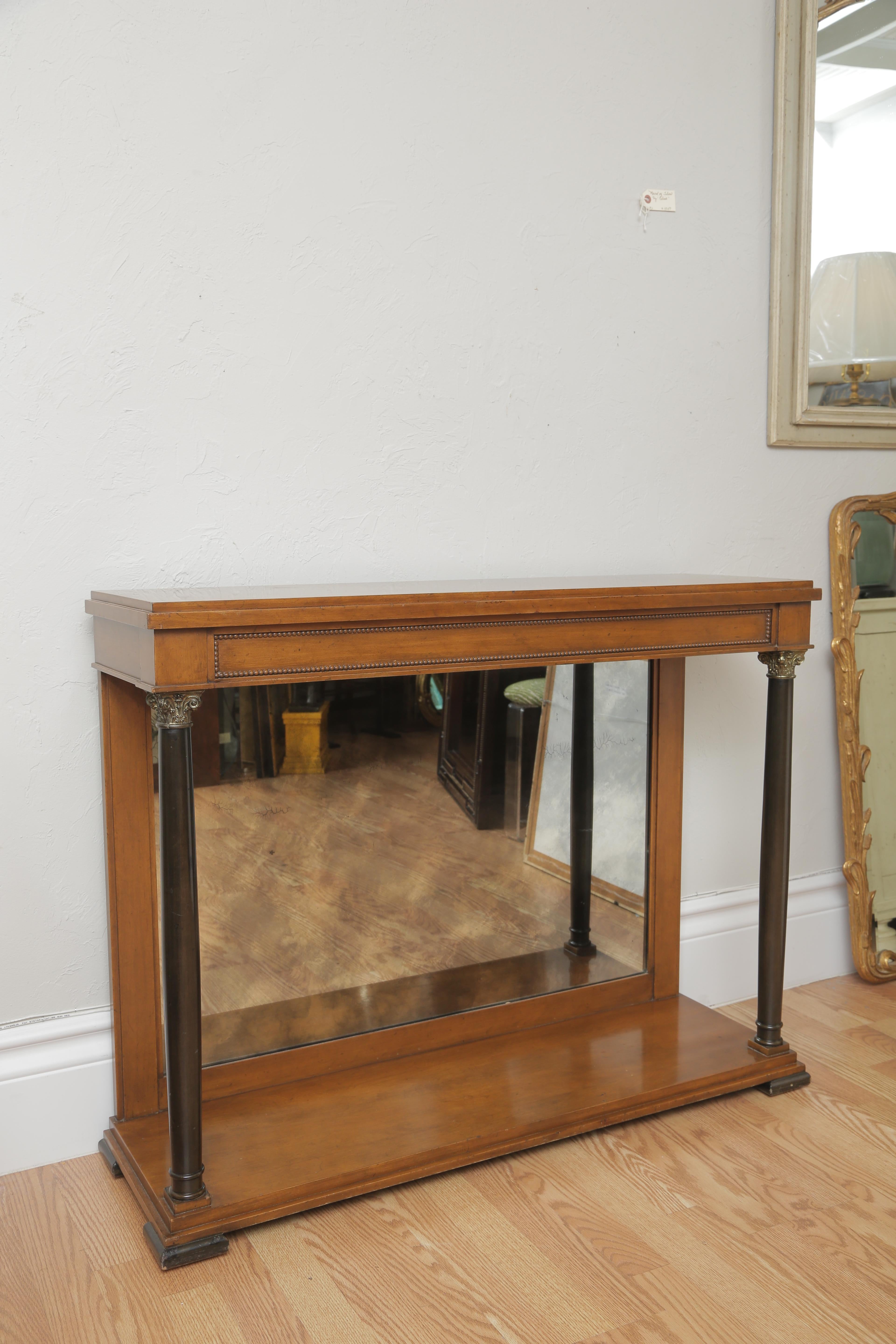 Mirrored front console with bottom shelf flanked by two column's in the Biedermeier style.