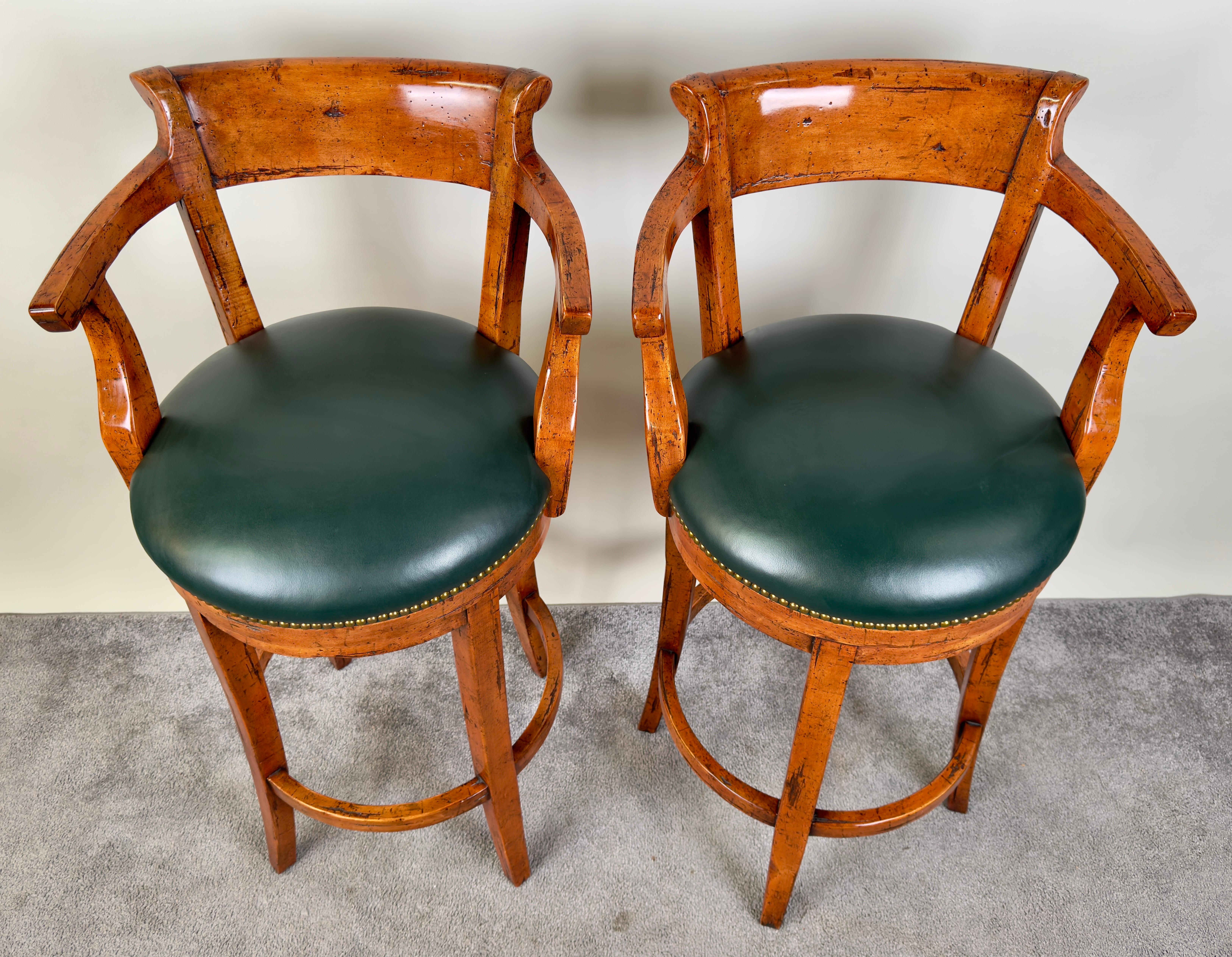 An exquisite pair of Biedermeier style barstools exemplifying a blend of classic design and contemporary comfort.  The sturdy oak wooden frames, with their rich, warm patina, showcase a natural grain that speaks to the high-quality craftsmanship.