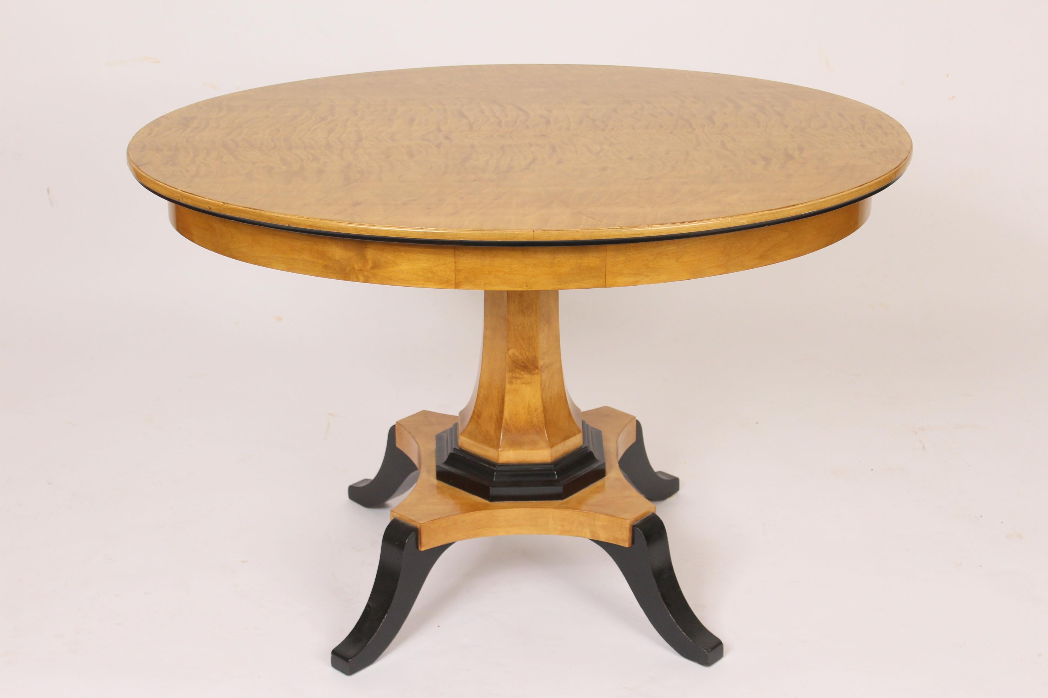 Biedermeier style oval occasional / center table, circa mid-20th century. With an oval feather birch top and ebonized feet.