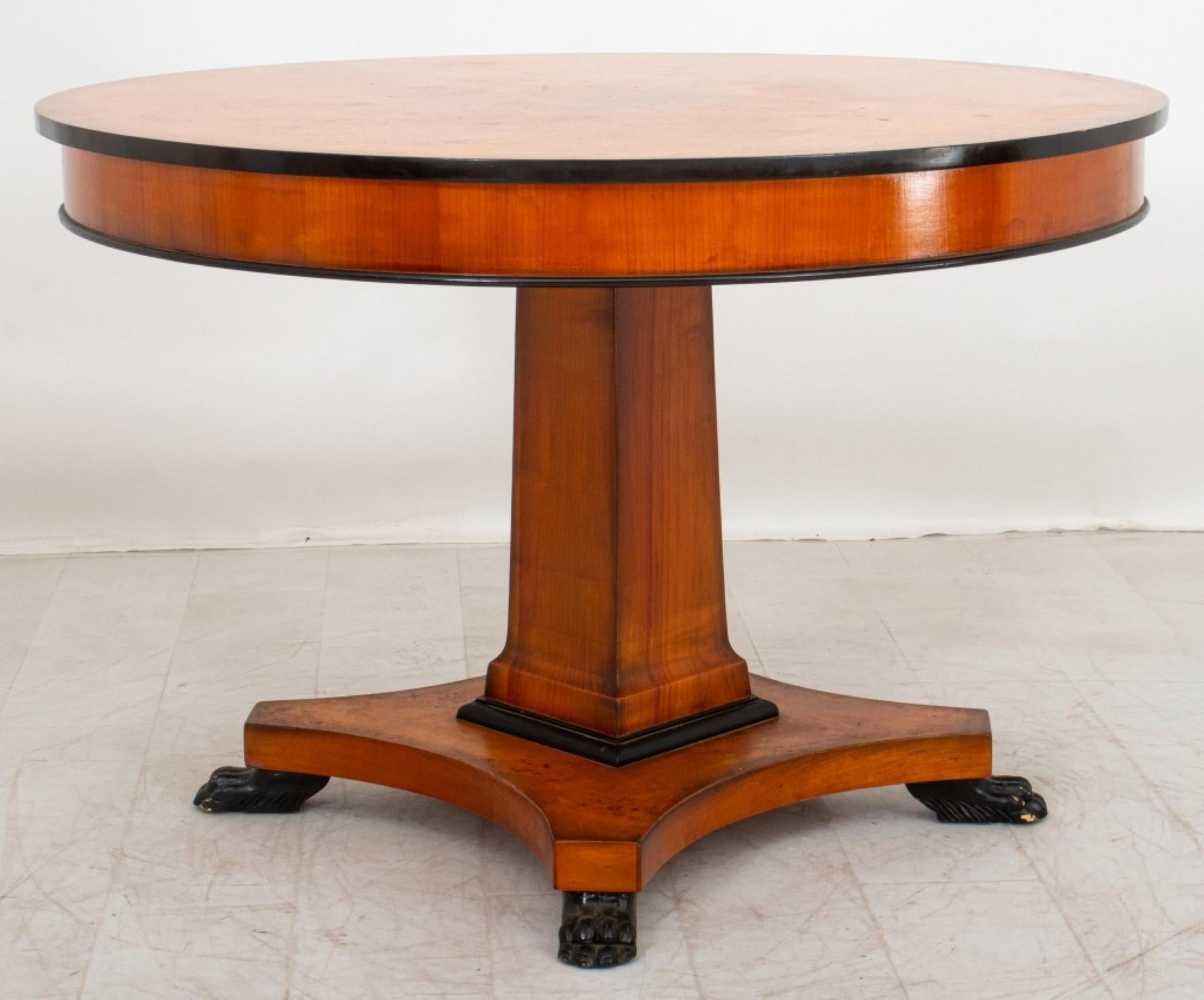 The Biedermeier Style Part Ebonized Burlwood Veneered Center Table has,

Dimensions of approximately 29.75 inches in height and 44.25 inches in diameter. This piece reflects characteristics of Neoclassical Style and Biedermeier design, showcasing