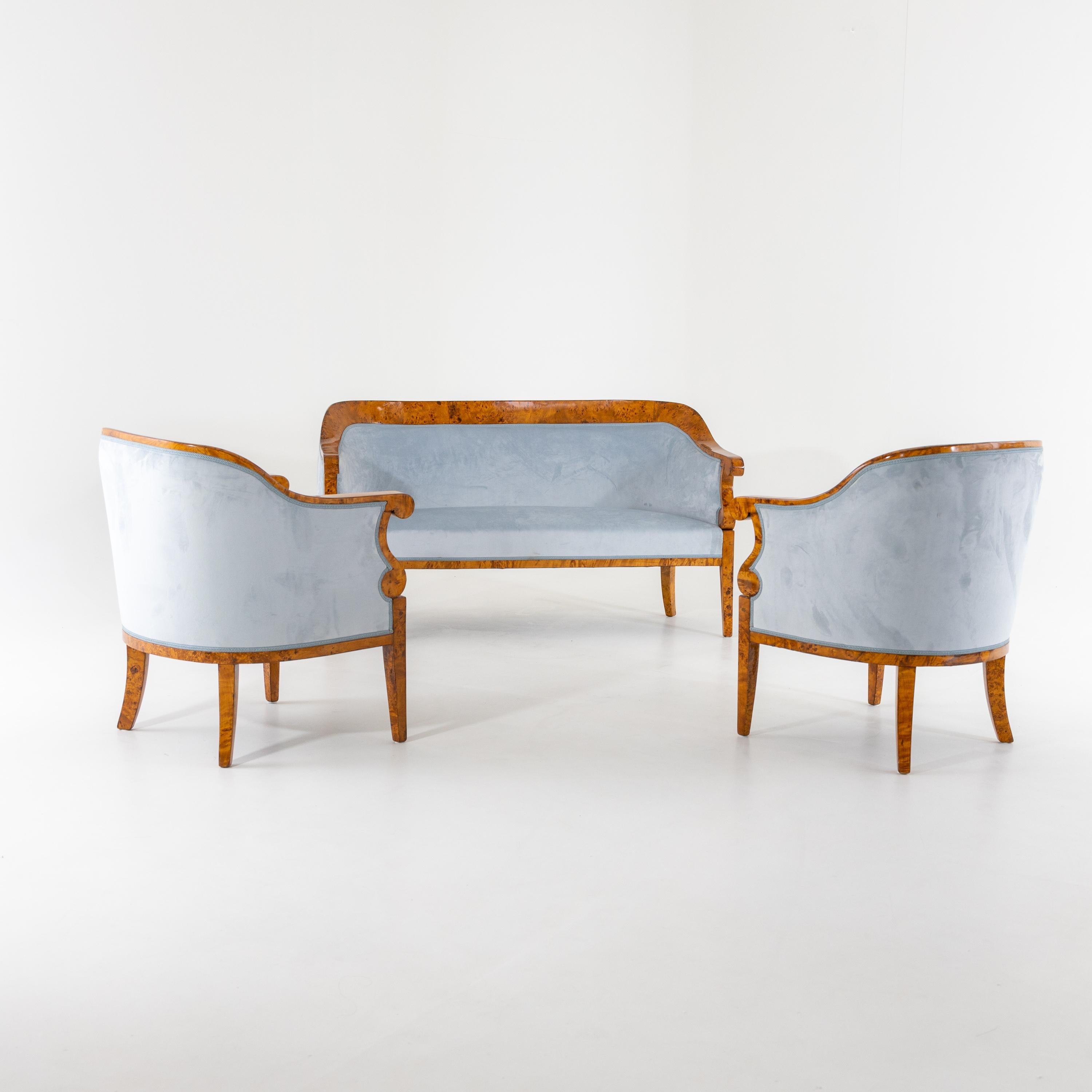 Seating group consisting of a sofa and two bergère chairs veneered in a poplar burl and newly covered with light blue velvet fabric. The group was professionally restored and hand-polished.