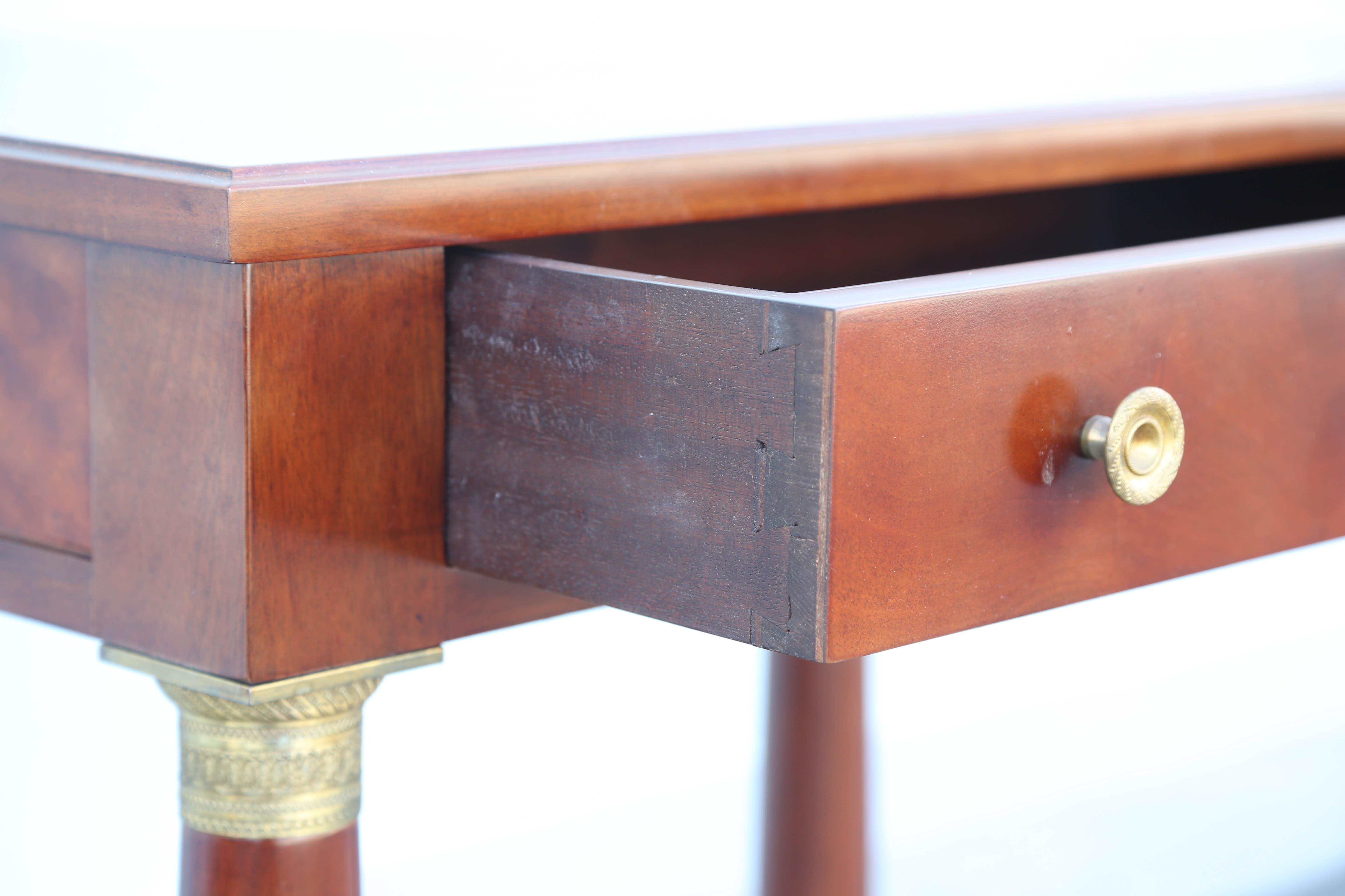Biedermeier style table with single drawer and bottom shelf. Very fine brass chasings.