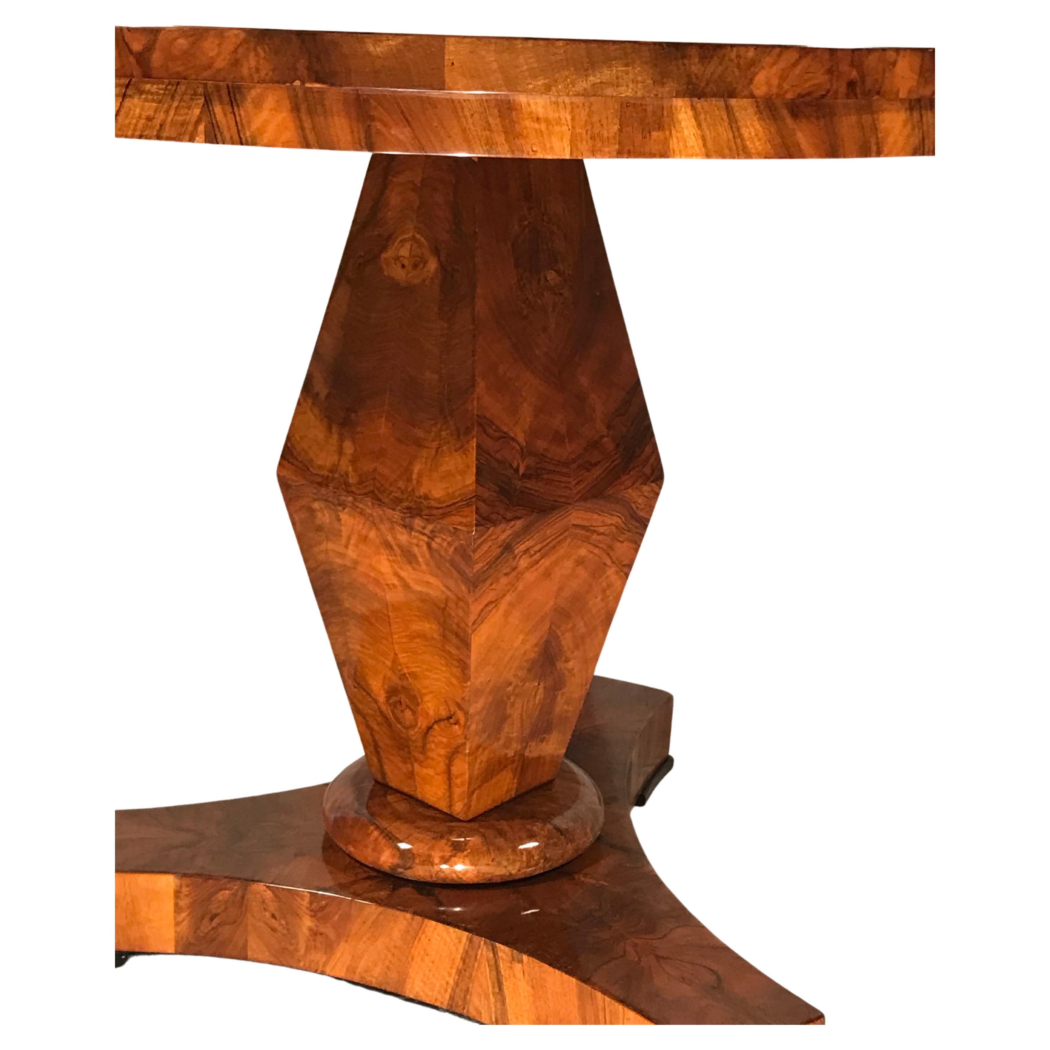 Experience the timeless sophistication of our exquisite Biedermeier table, where meticulous design meets refined craftsmanship. This captivating piece boasts a round top that effortlessly graces a quadrangular rhombus-shaped foot, providing a