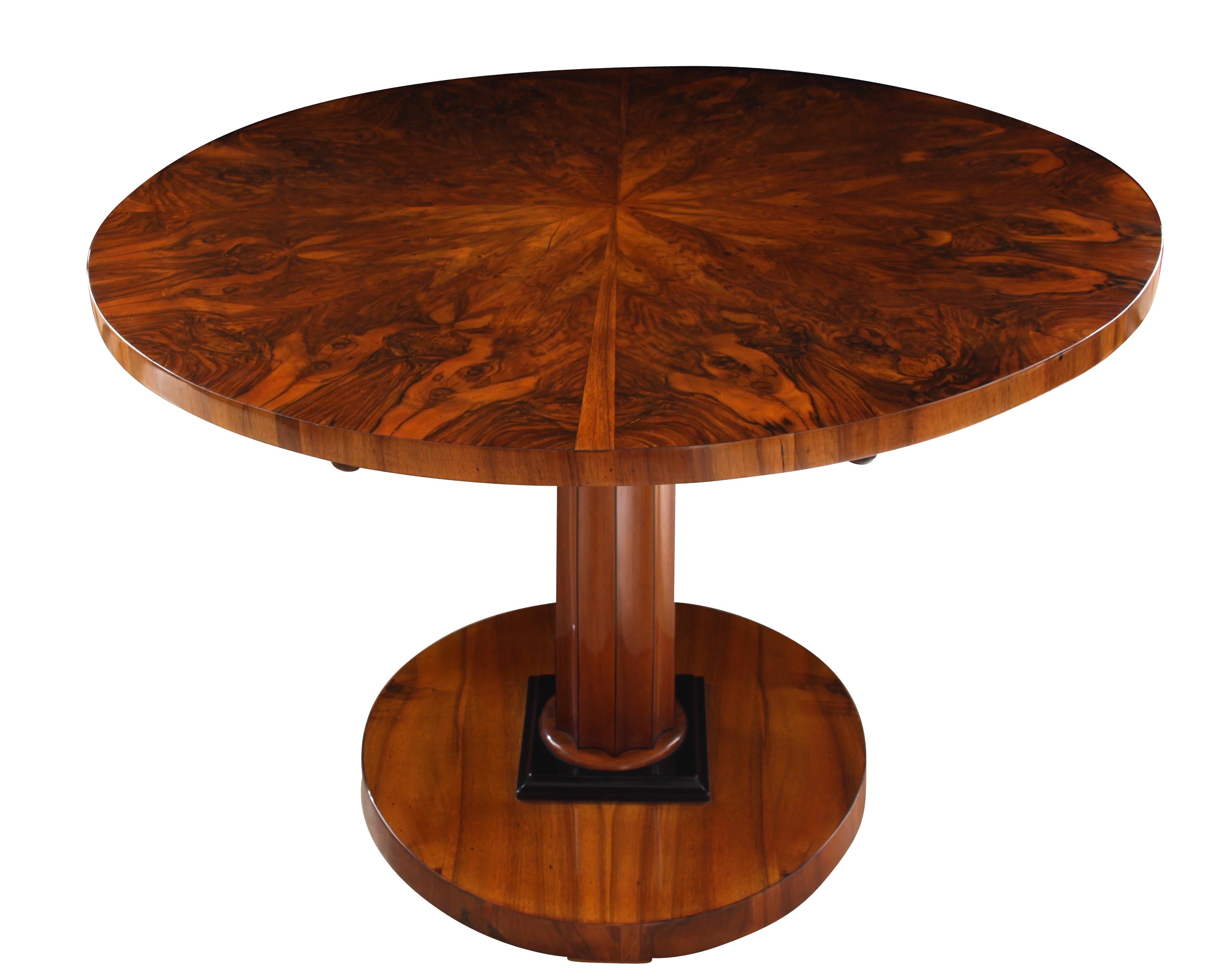 Elegant, neoclassical Biedermeier Tilt-Top table from Vienna, Austria, circa 1825.

Wonderful star-shaped veneer on the plate. 
Cannelured middle column-leg made of walnut solid wood.
Round, ebonized pedestral and ebonized tips of the