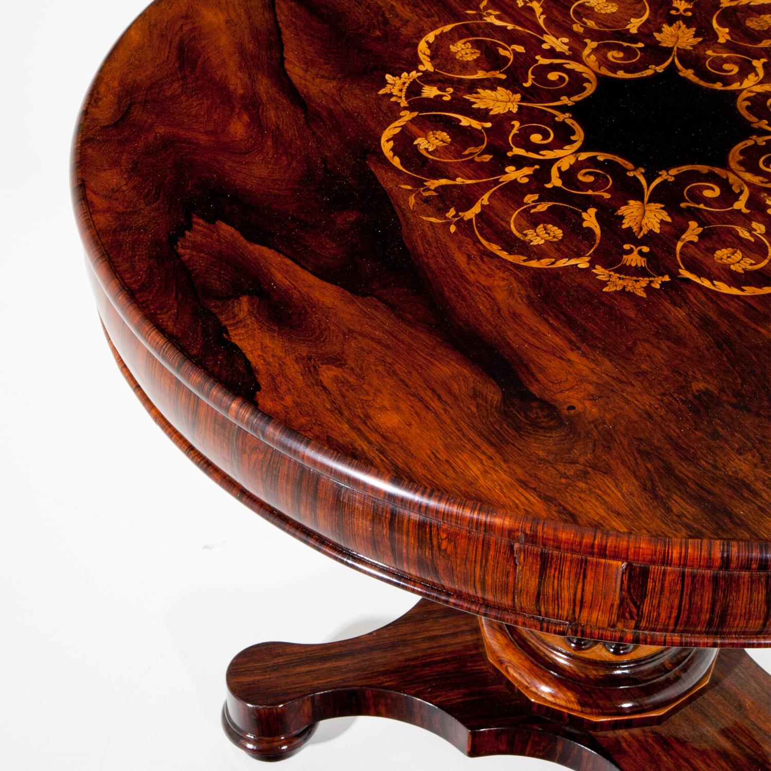 Low Biedermeier salon table standing on a trefoil base, the round tabletop shows vine inlays and three-quarter columns surround the Stand. Very beautiful veneer pattern. The table was professionally refurbished and hand-polished.