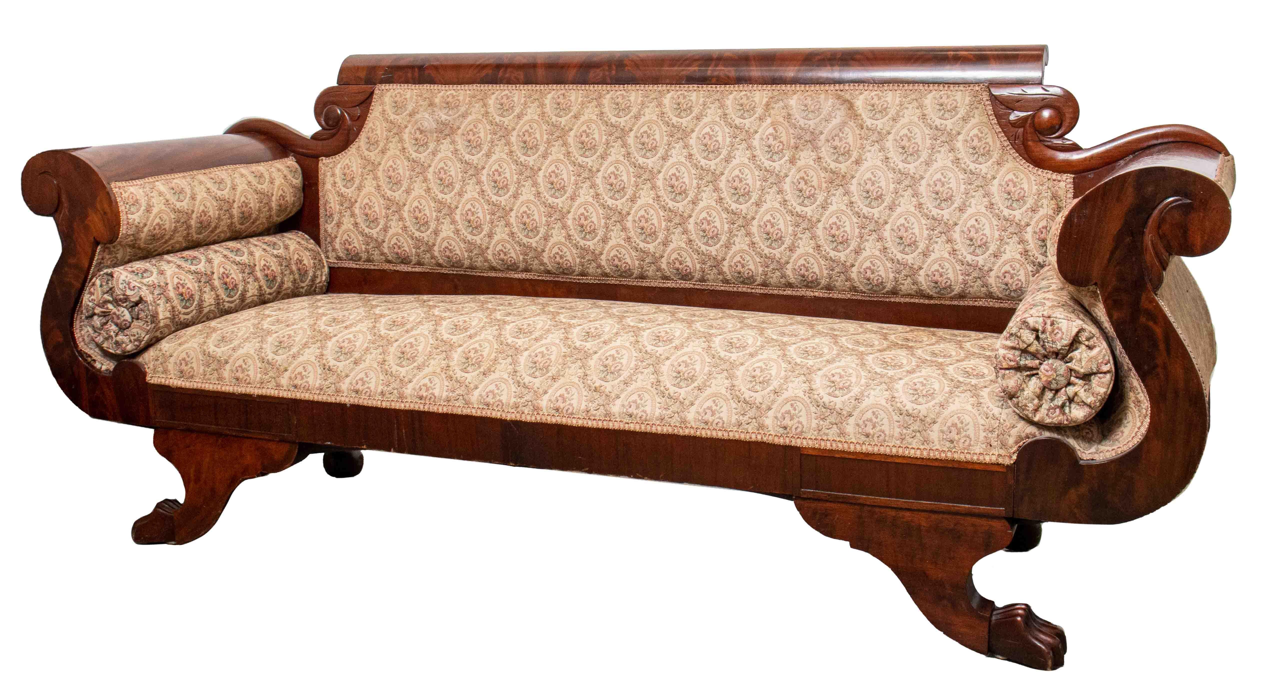 Biedermeier sofa with curved arms and two claw feet, with cream and pink floral upholstery on the back, seat, and two cylindrical pillows. Seat height: 17