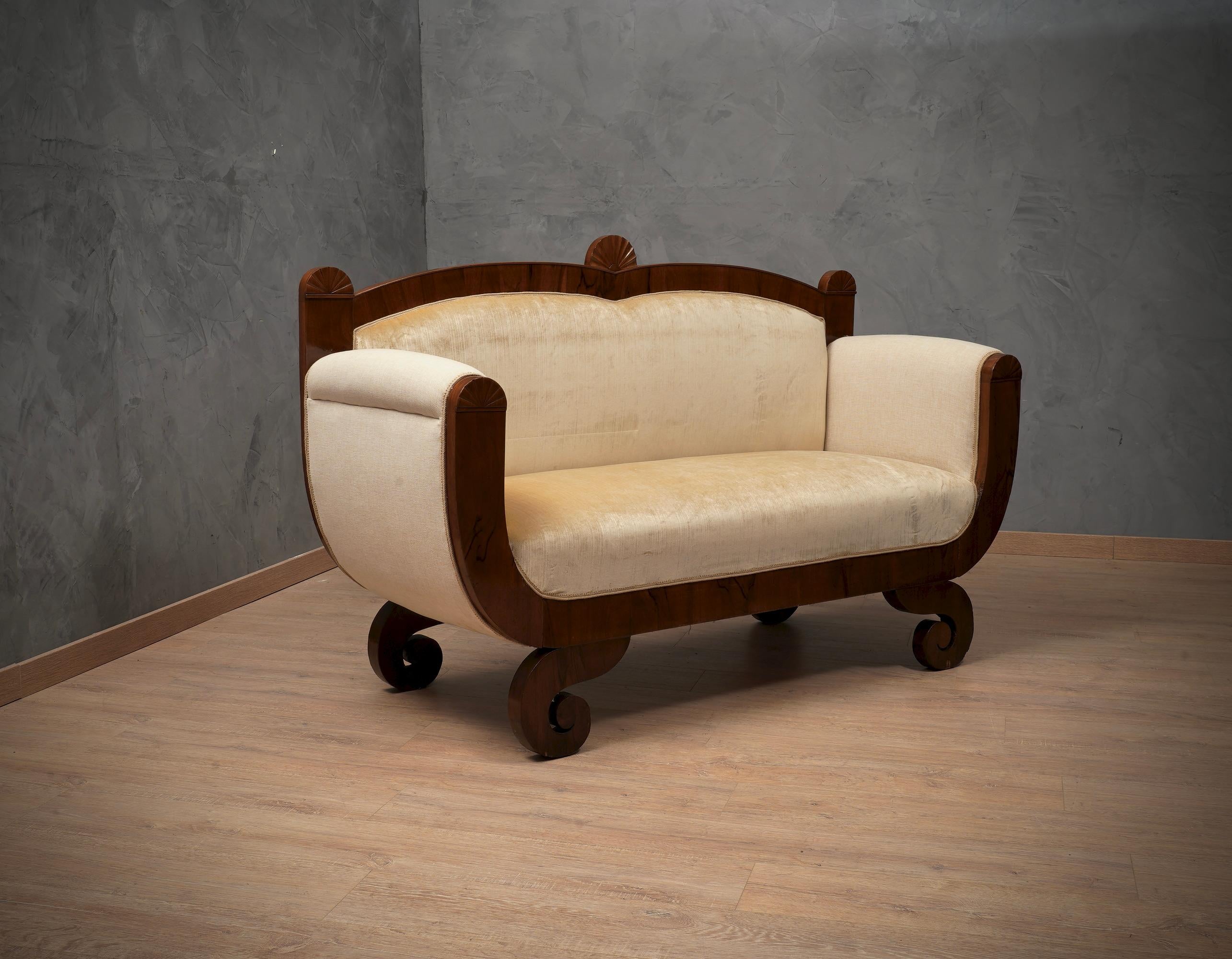 Biedermeier two-seat sofa. Sofa all veneered in walnut wood and covered in beige color velvet and combined fabric. 

The sofa is small in size, and seats two people well. It is made up of a band veneered in walnut wood, which starts from an