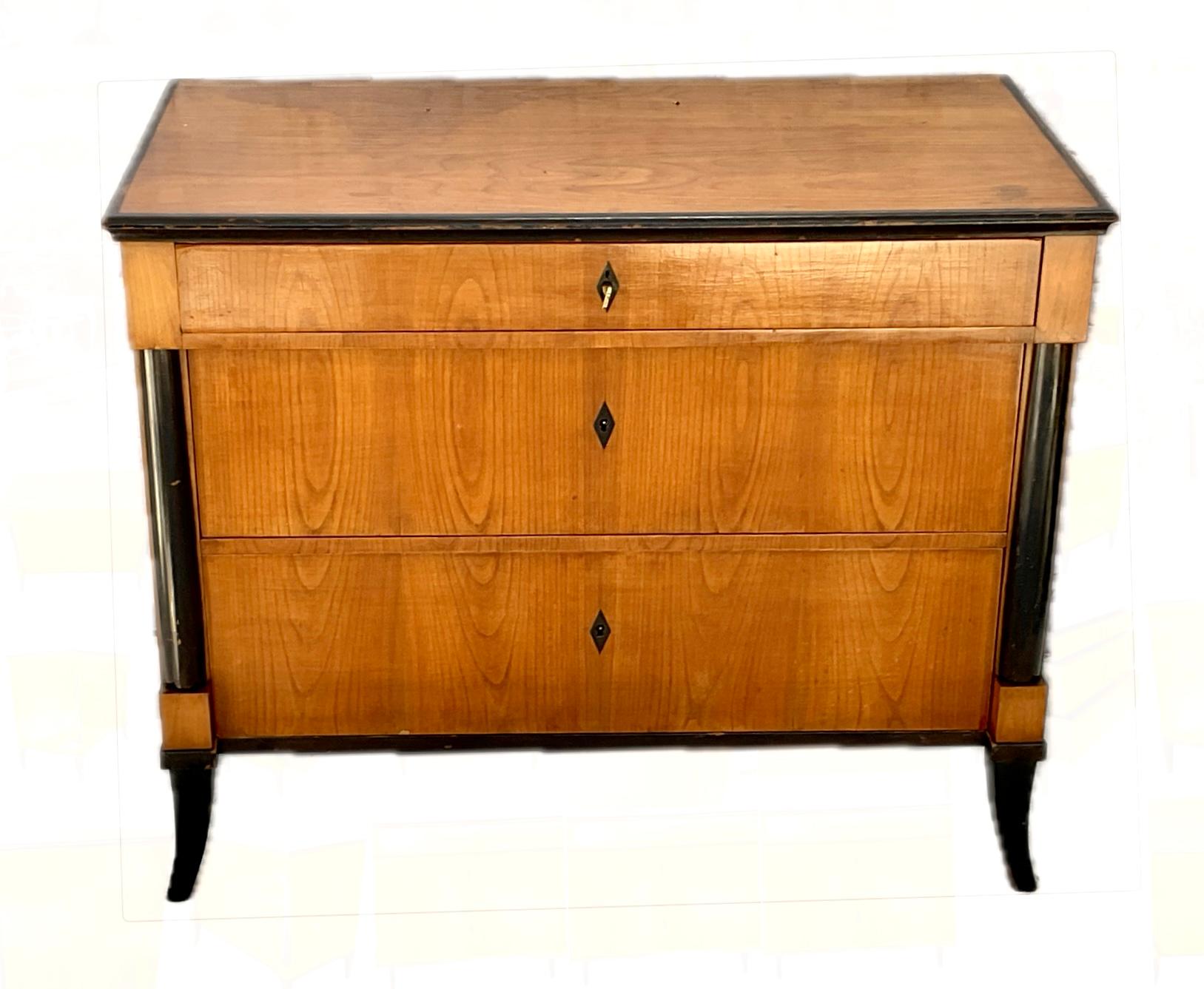 19th Century Biedermeier Walnut Chest of Drawers made in Germany. Chest features three drawers with individual keyholes. Chest has a rectangular, clean-lined silhouette, typical of the Biedermeier style--pared down and balanced--without excessive