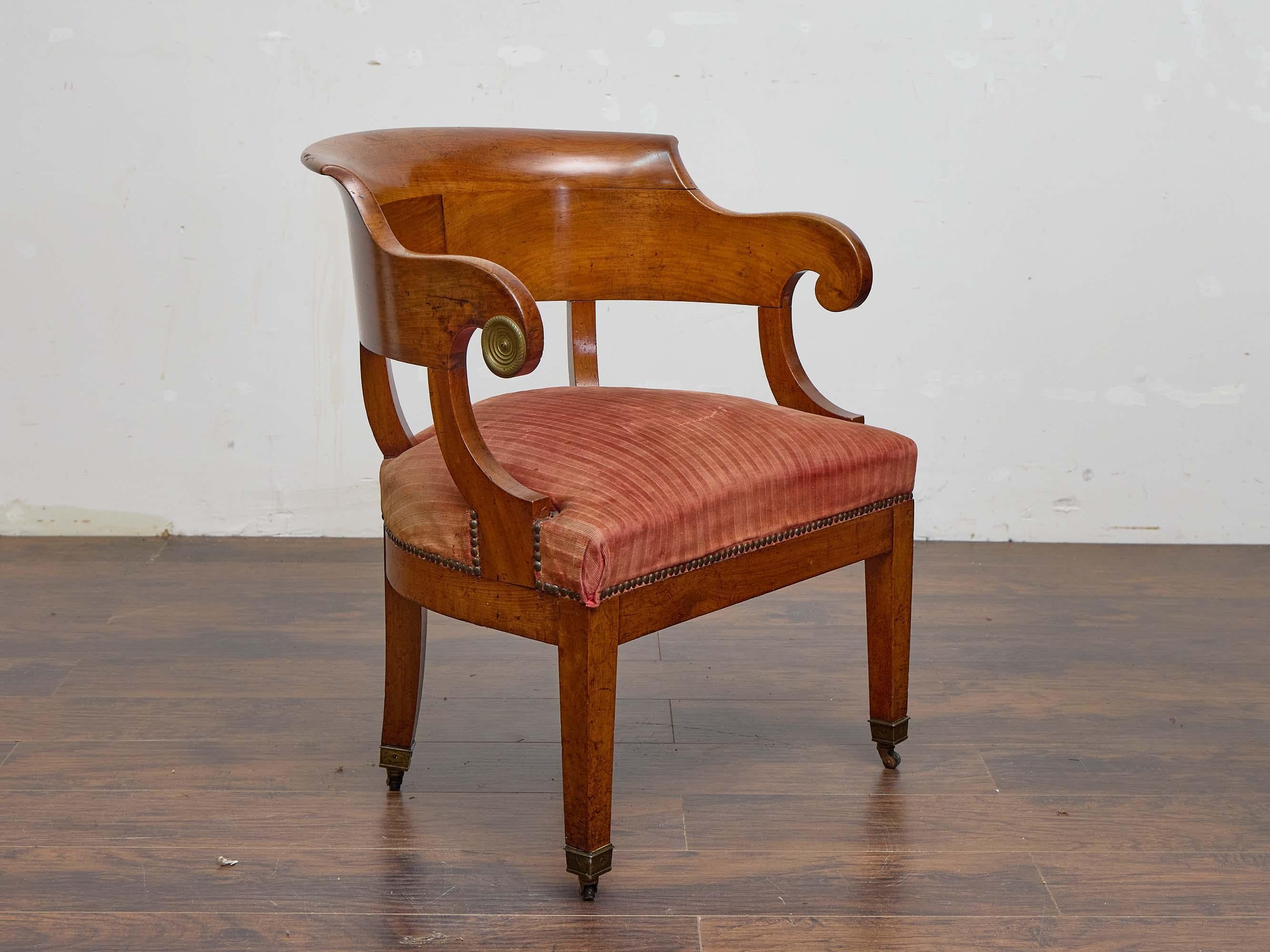 Cette chaise baquet Biedermeier du XIXe siècle a la présence tranquille et confiante que les meubles en noyer de cette période possèdent si bien. Le dossier incurvé s'étend en une seule ligne fluide, sculptée dans du noyer et façonnée pour vous