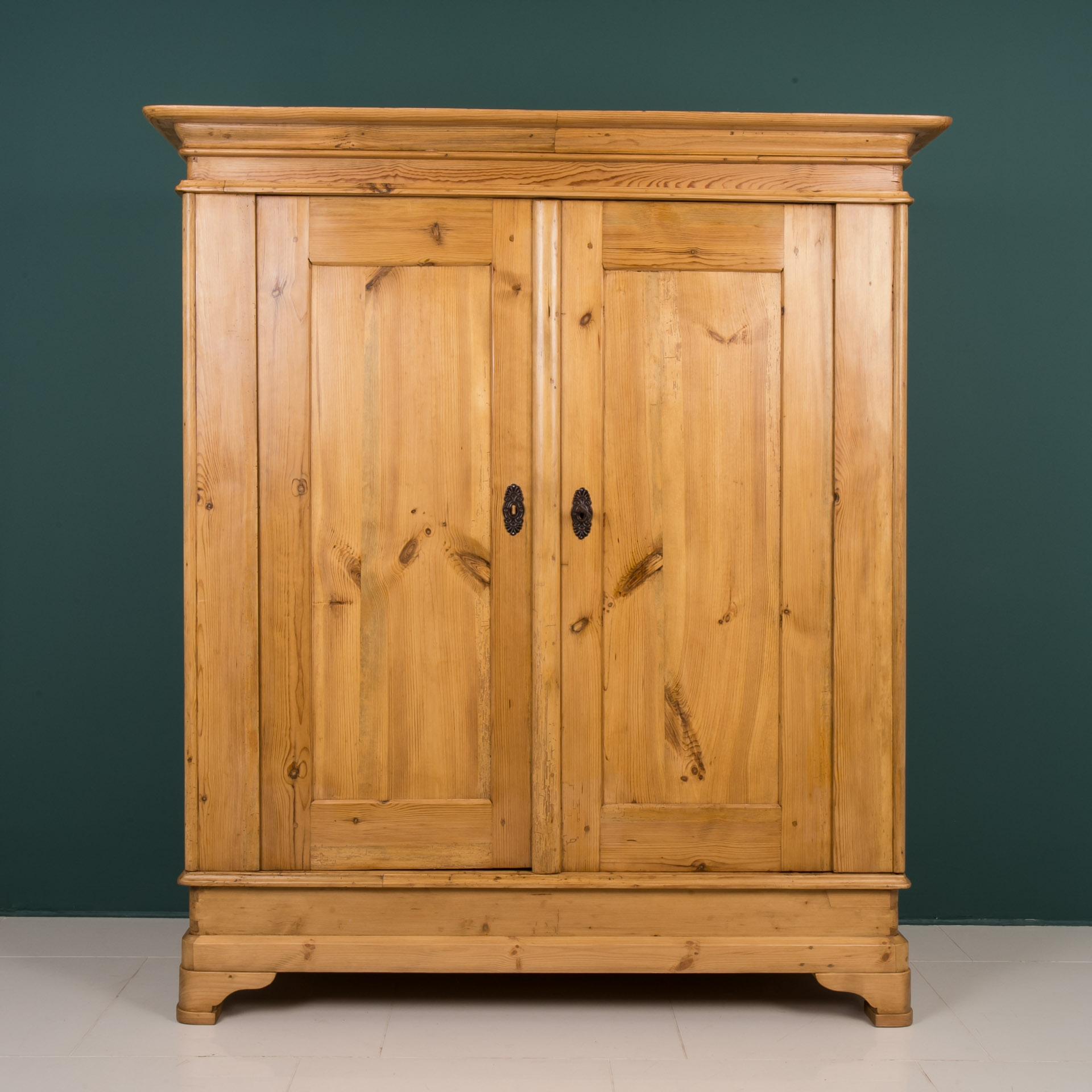 This Biedermeier wardrobe was made in Germany in first half of 19th century. The piece is made of pine wood. It has been carefully renovated and finished with high quality wood wax. The wardrobe can be easily unfolded thanks to original construction