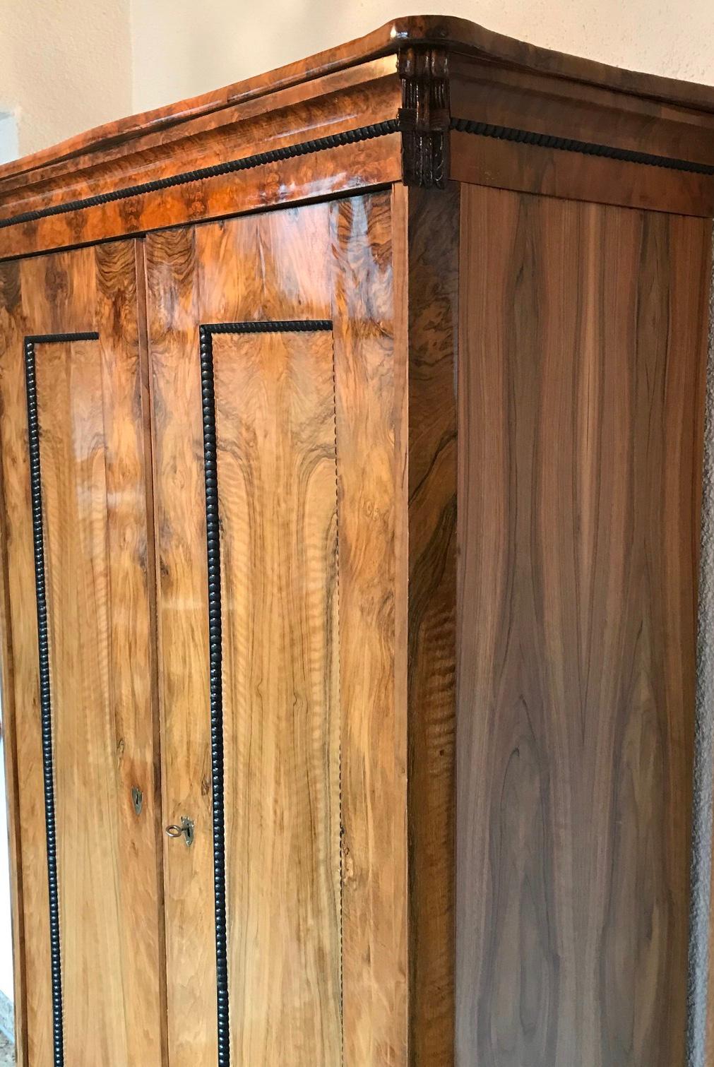 Biedermeier wardrobe, South German 1820, walnut veneer with ebonized and hand carved details. Two doors with shelf’s on the left side and two rows of coat racks on the right side. In very good condition.
The wardrobe will be shipped from Germany.