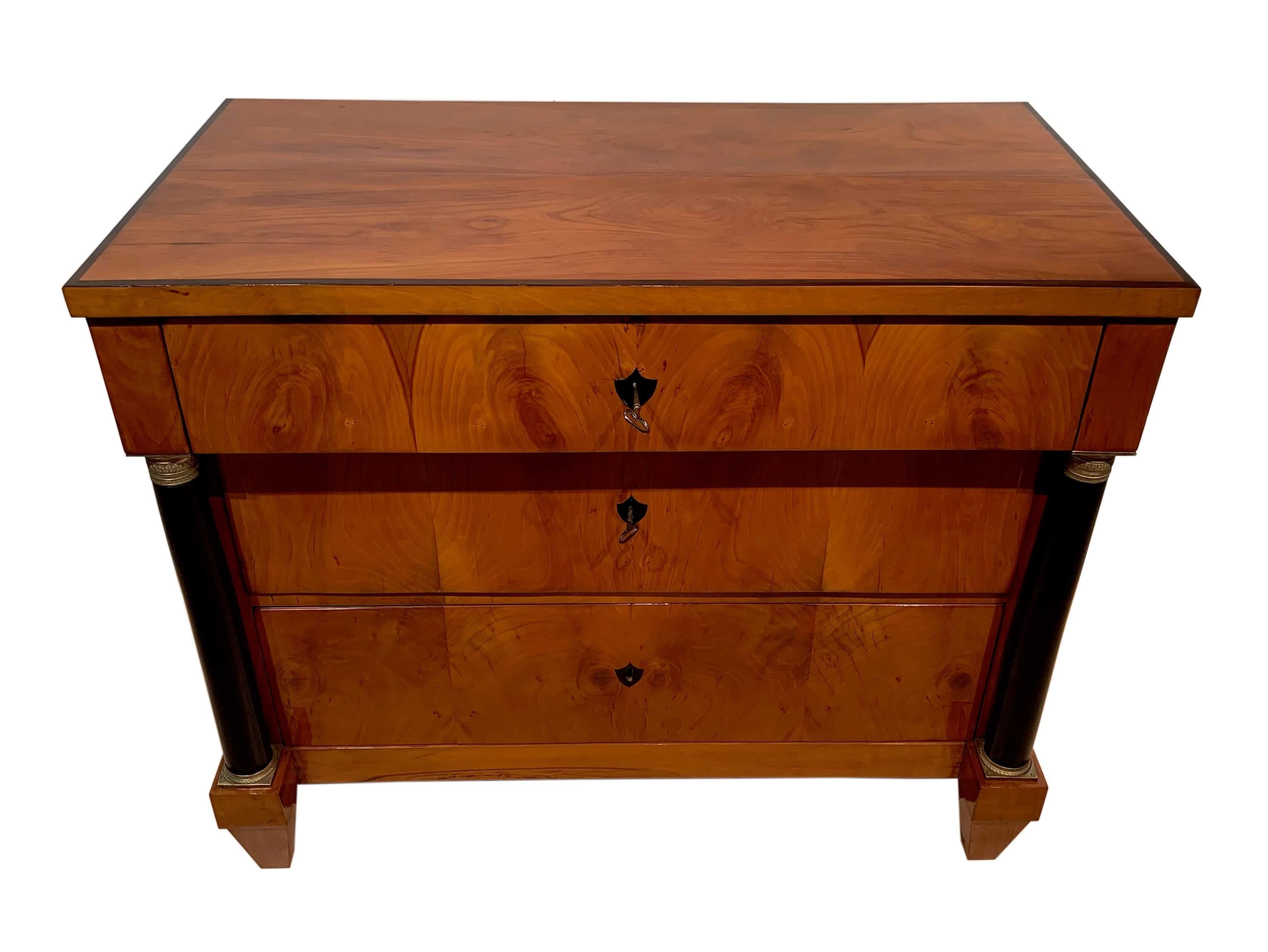 Very beautiful, and sober Biedermeier writing Commode / Chest of Drawers / Secretaire

Extractable fold-out writing plate in top drawer with 4 little drawers with brass knobs, and spacious middle compartment.
Two big drawers in the middle and bottom