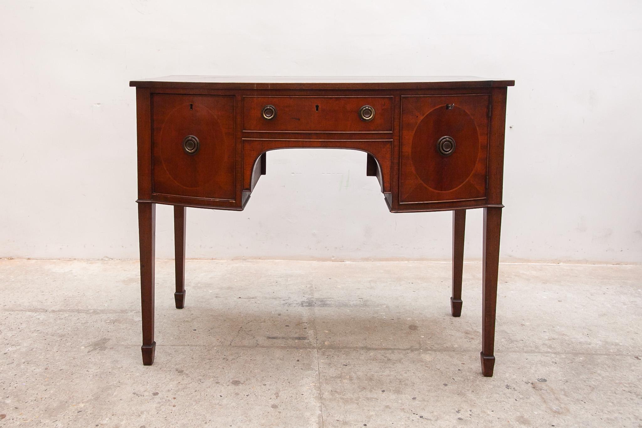 This small Lady desk was crafted in Austria. The top is wonderfully smooth and displays the woodgrain beautifully in walnut veneer. The apron houses three drawers, all with quality brass banding inset into the paneling. The two side drawers and
