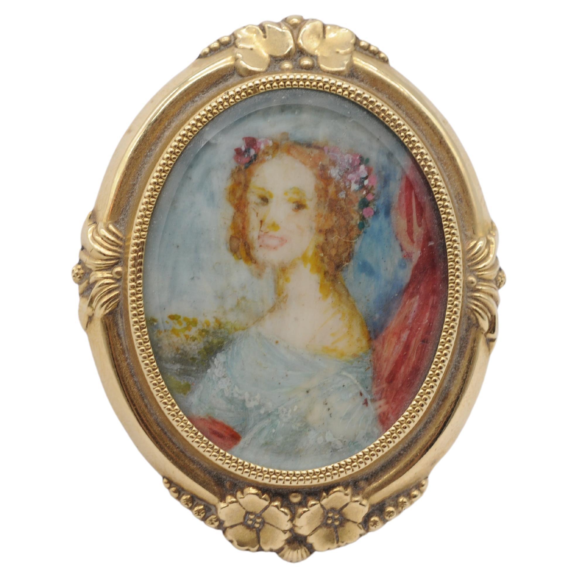 Step into the enchanting world of the Biedermeier era with this exquisite brooch dating back to 1840-1860. Adorned with the delicate depiction of a young and beautiful woman, this brooch is a true testament to the artistic craftsmanship of its