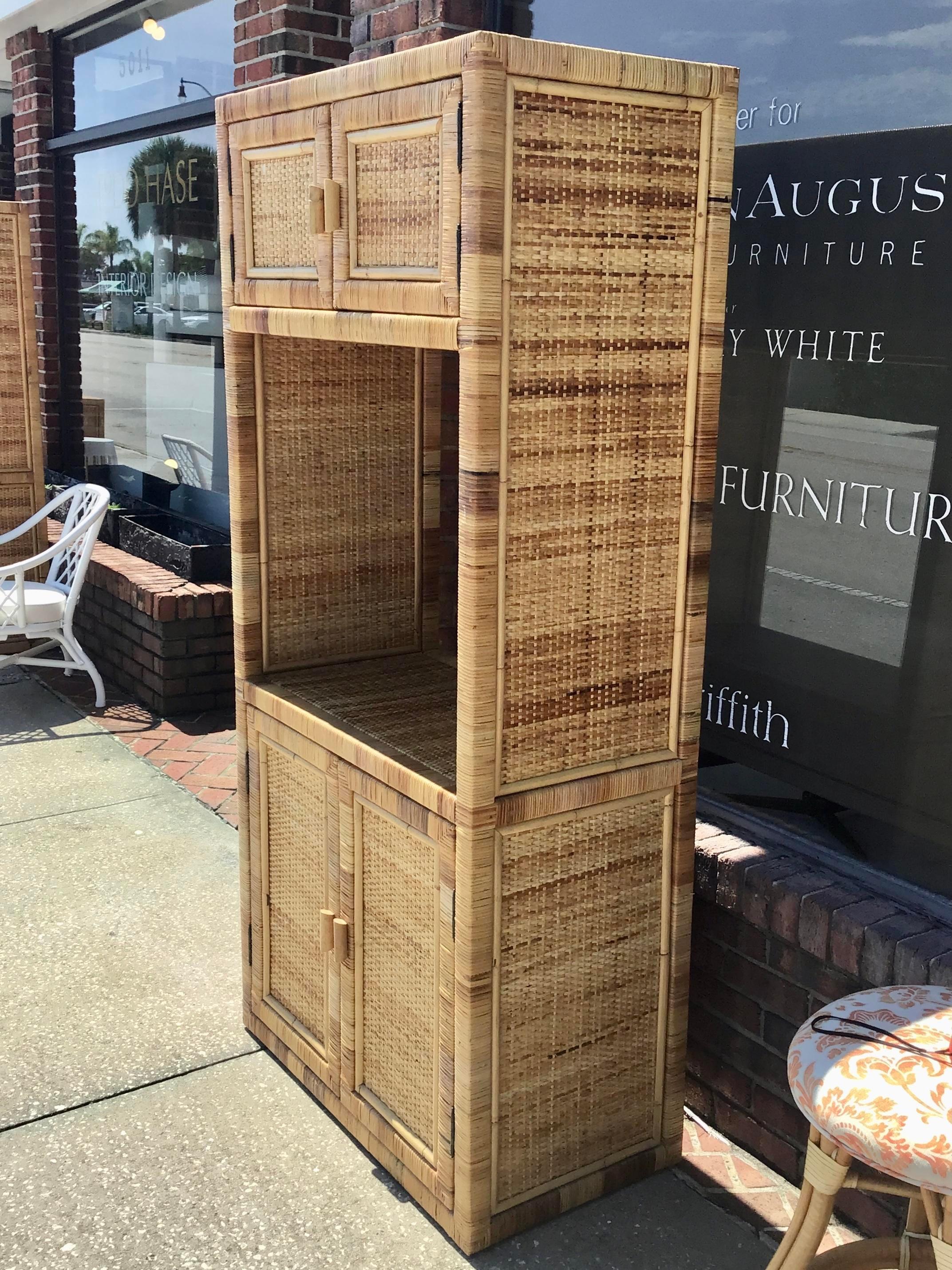 Boho Chic Bielecky Brothers rattan bar with upper and lower storage with doors for your bottles and glasses. A must for a fun boho chic bar at home.