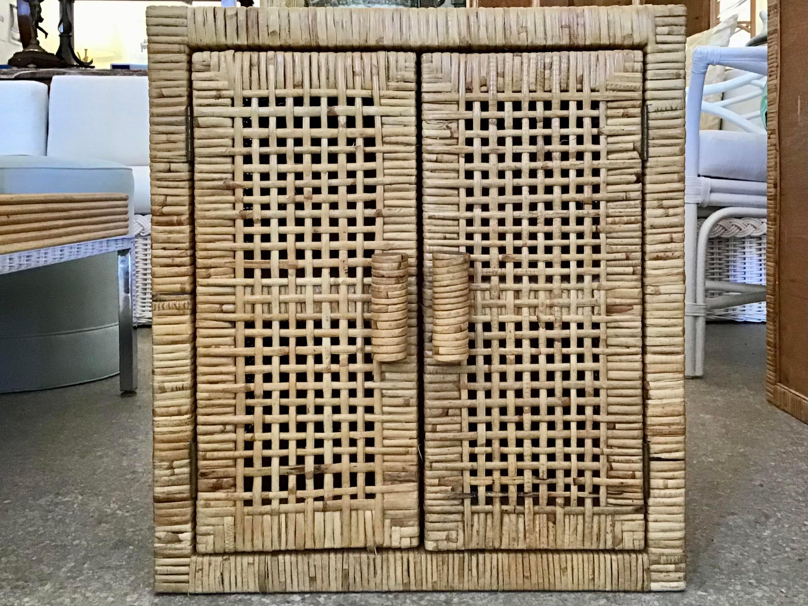 Fabulous small Bielecky brothers boho chic rattan two door cabinet with shelf. This is a great addition to your bar and kitchen for great storage and decor.