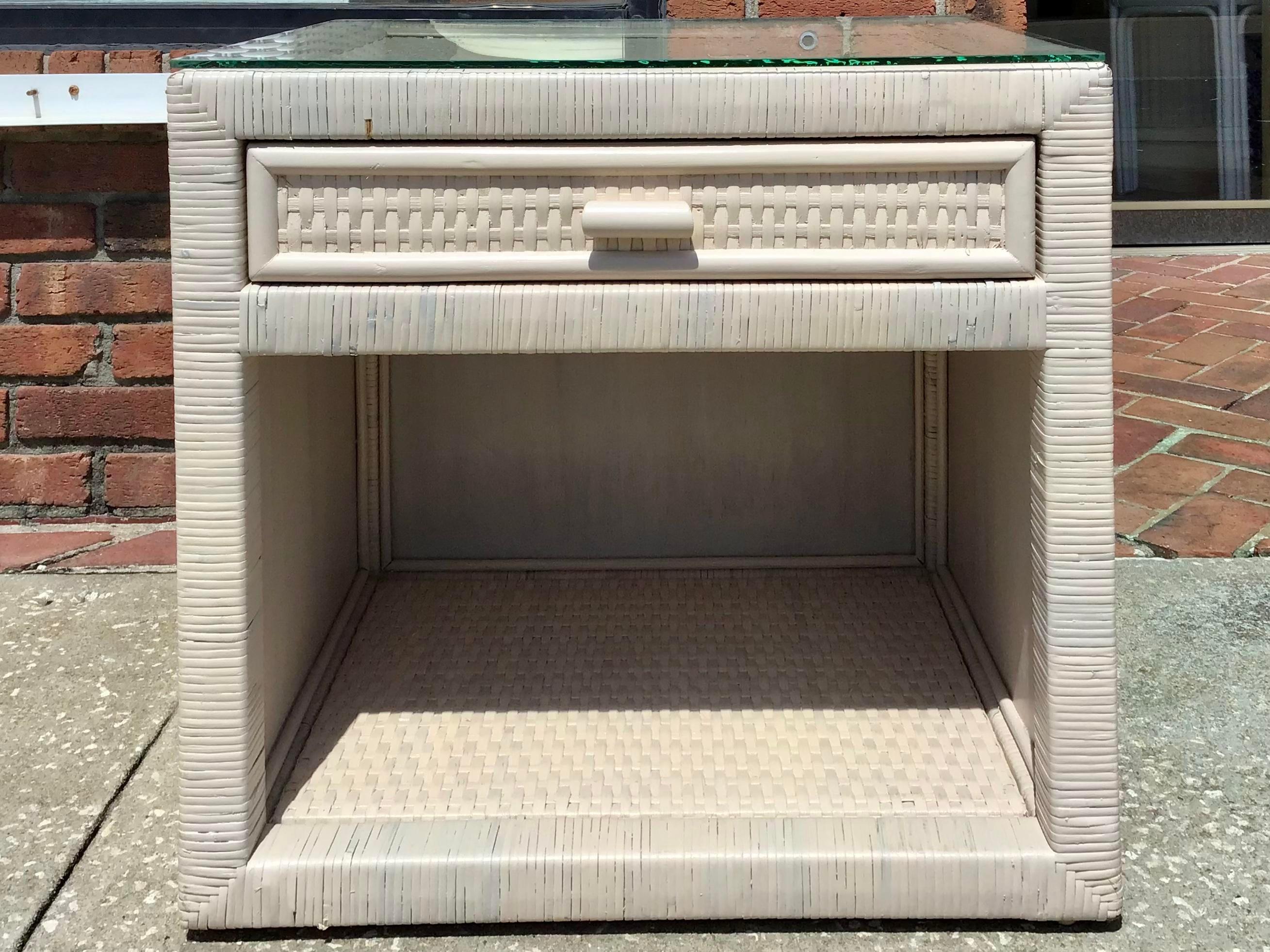 This is an unusual white washed finish Boho Chic Bielecky Brothers rattan nightstand with a drawer for storage. The white washed finish makes it an unusual color for a Bielecky Brothers signature design. This nightstand includes both practical and