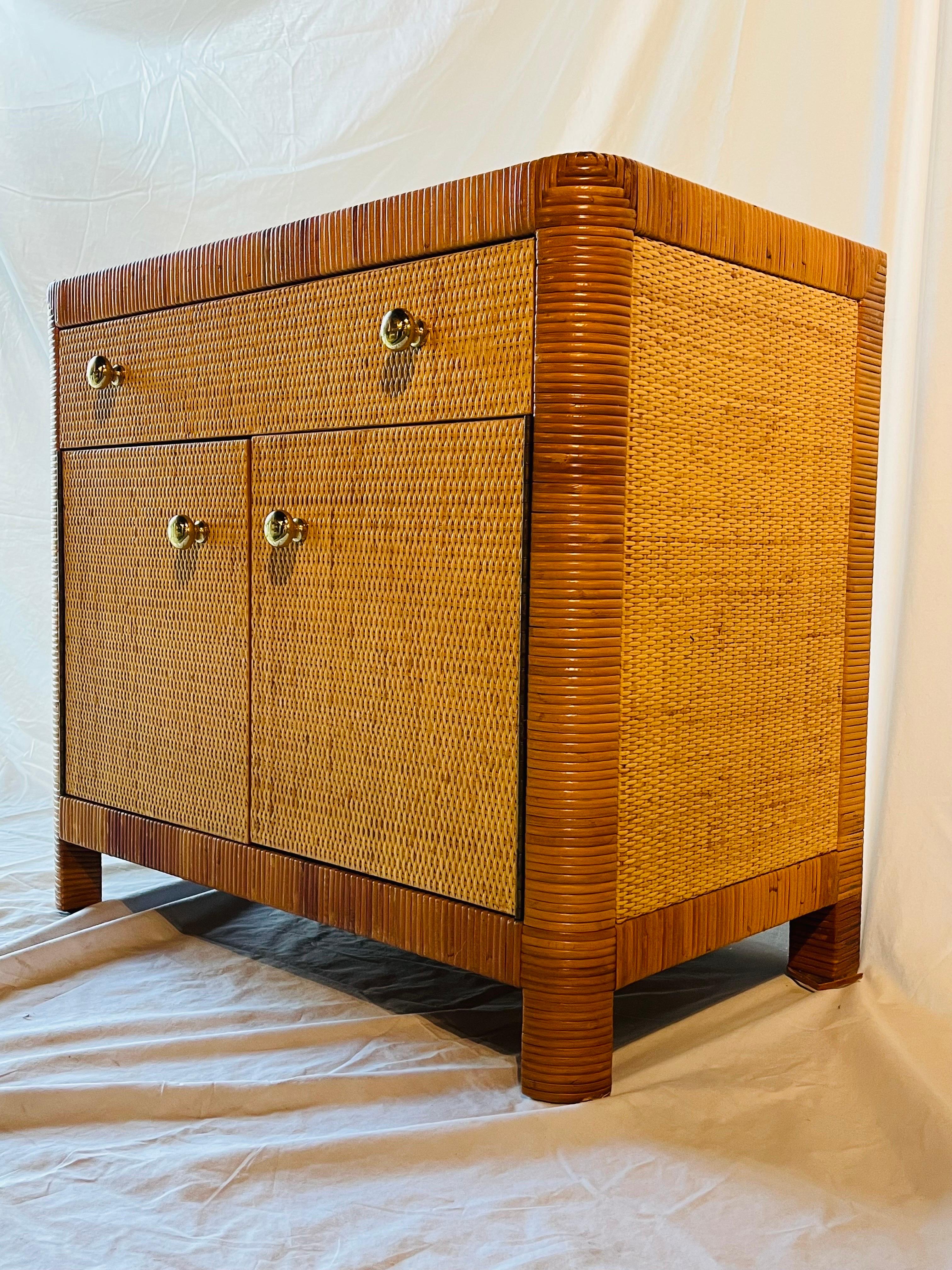 A vintage marked and documented Bielecky Brothers wrapped rattan and cane chest, night stand or cabinet with two doors and one drawer. Bielecky Brothers has a long history in the United States, starting in 1903 when the Bielecky Brothers emigrated
