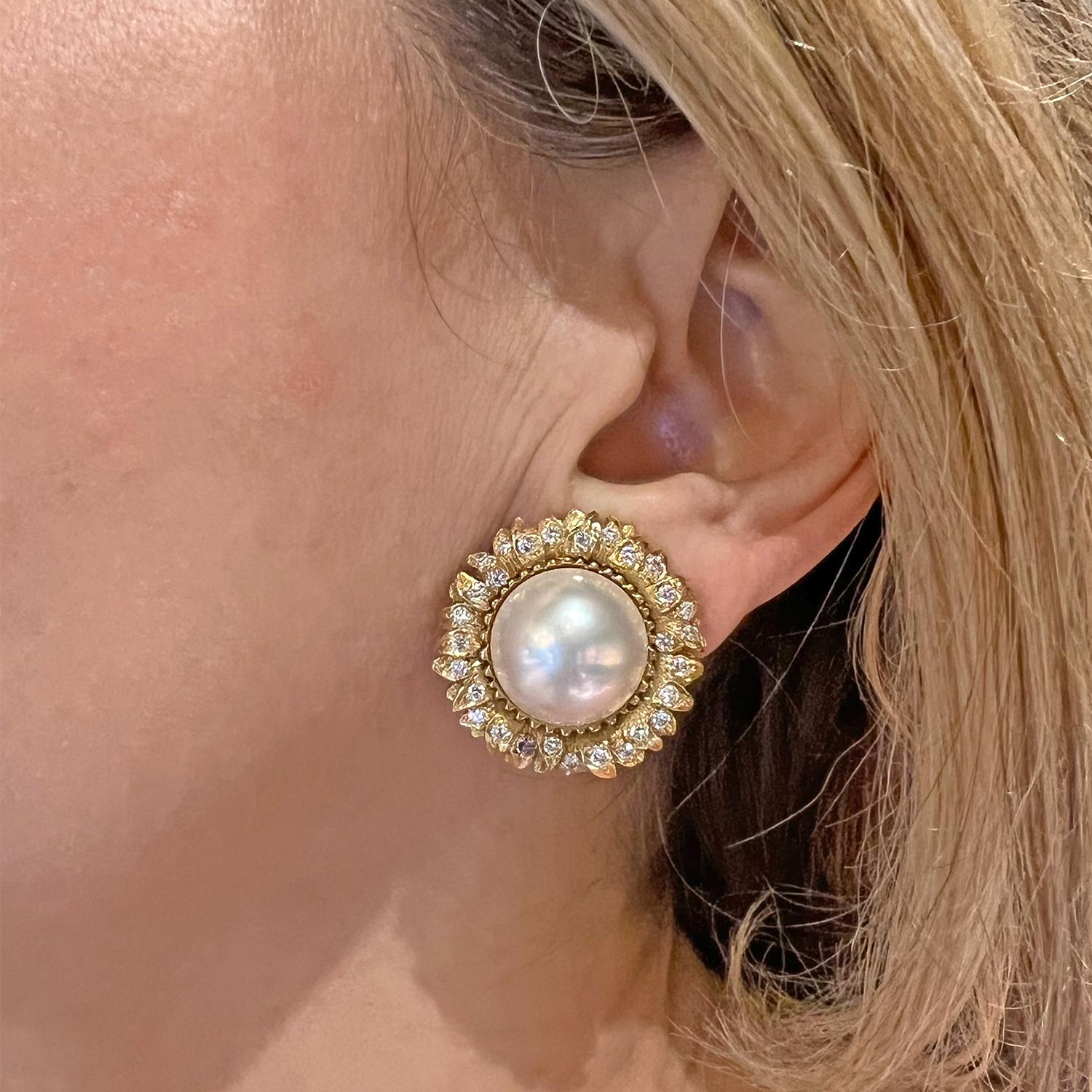 18-karat yellow gold sunflower earrings by renowned designer Robert Bruce Bielka. These exquisite earrings boast a central mabe pearl, encircled by twenty-eight round brilliant-cut diamonds, creating a sparkling sunflower motif.

Measuring