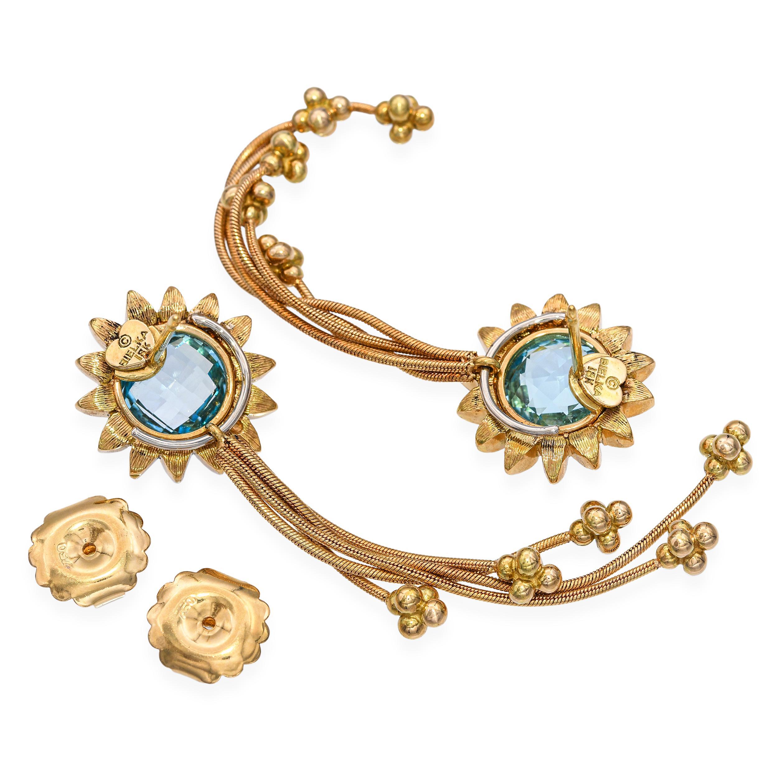 Ces boucles d'oreilles Bielka sont magnifiquement réalisées en or jaune 18 carats et conçues dans un élégant motif floral. Chaque boucle d'oreille est sertie d'une topaze richement colorée, qui ajoute de la brillance et de la chaleur à l'orfèvrerie