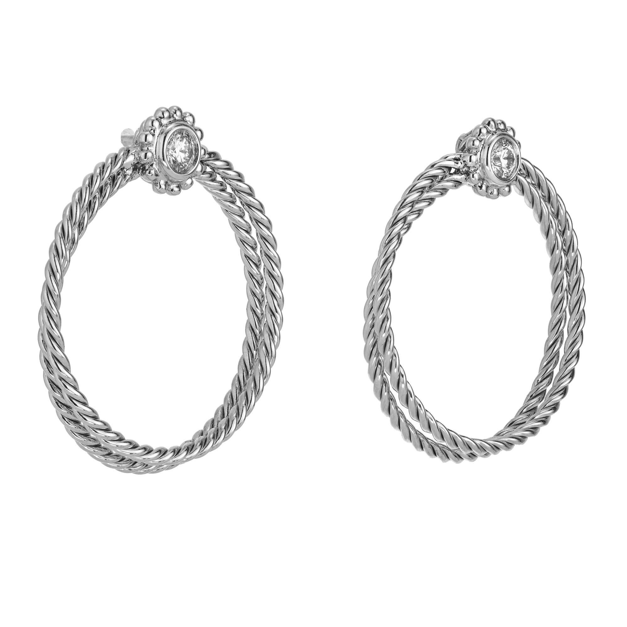 Bielka .30ct diamond twisted wire gold hoop earrings, a true testament to elegance and craftsmanship. These exquisite earrings are mounted with bezel set round full cut diamonds that sit above twisted double wire hoops. Each diamond is meticulously