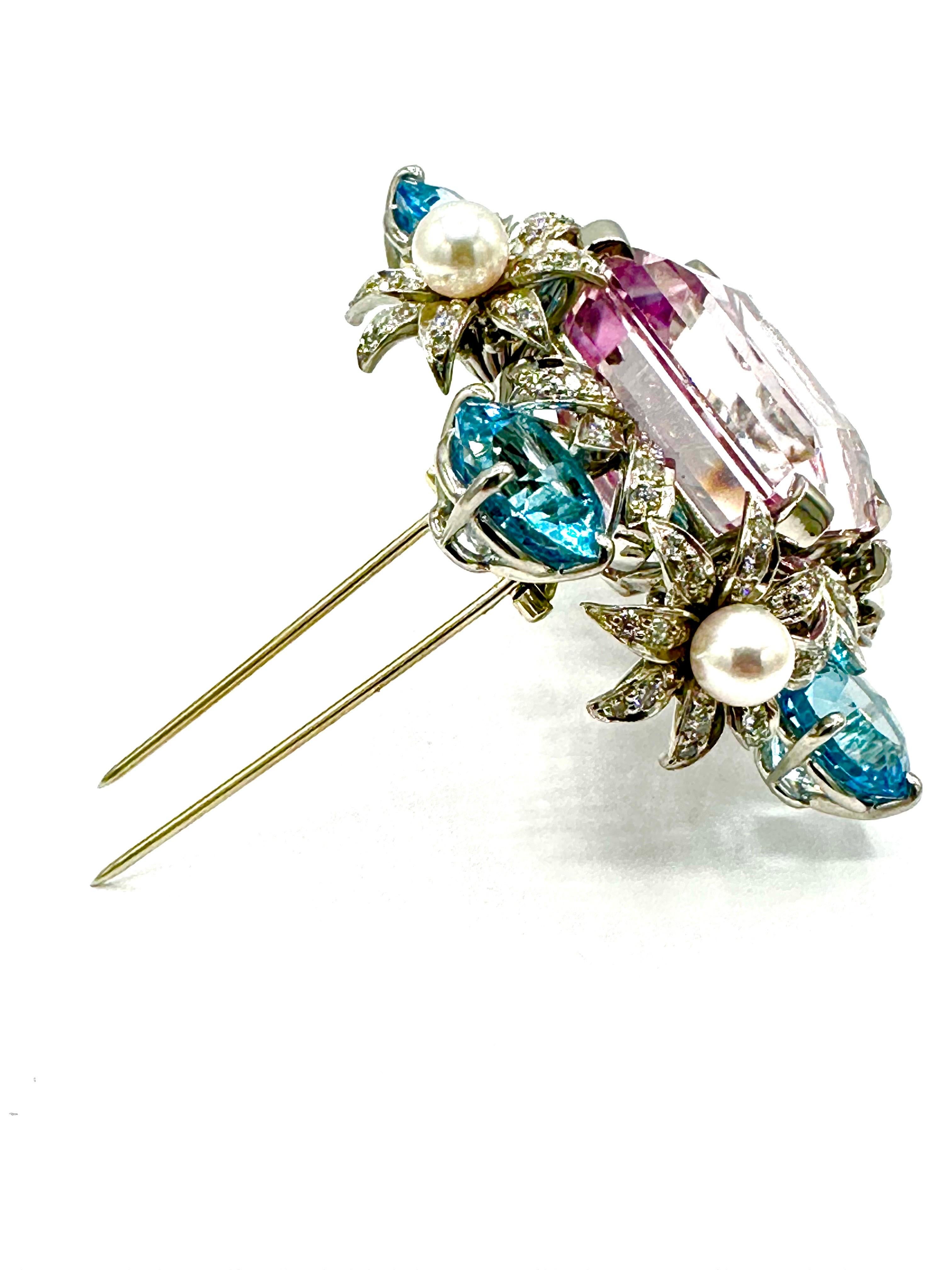 An absolutely gorgeous brooch that everyone will notice!  Designed and created by Bielka, this brooch features a 60.00 carat step cut Kunzite, framed in a Diamond, Pearl and Blue Topaz floral motif made all in platinum.  The Diamonds are round
