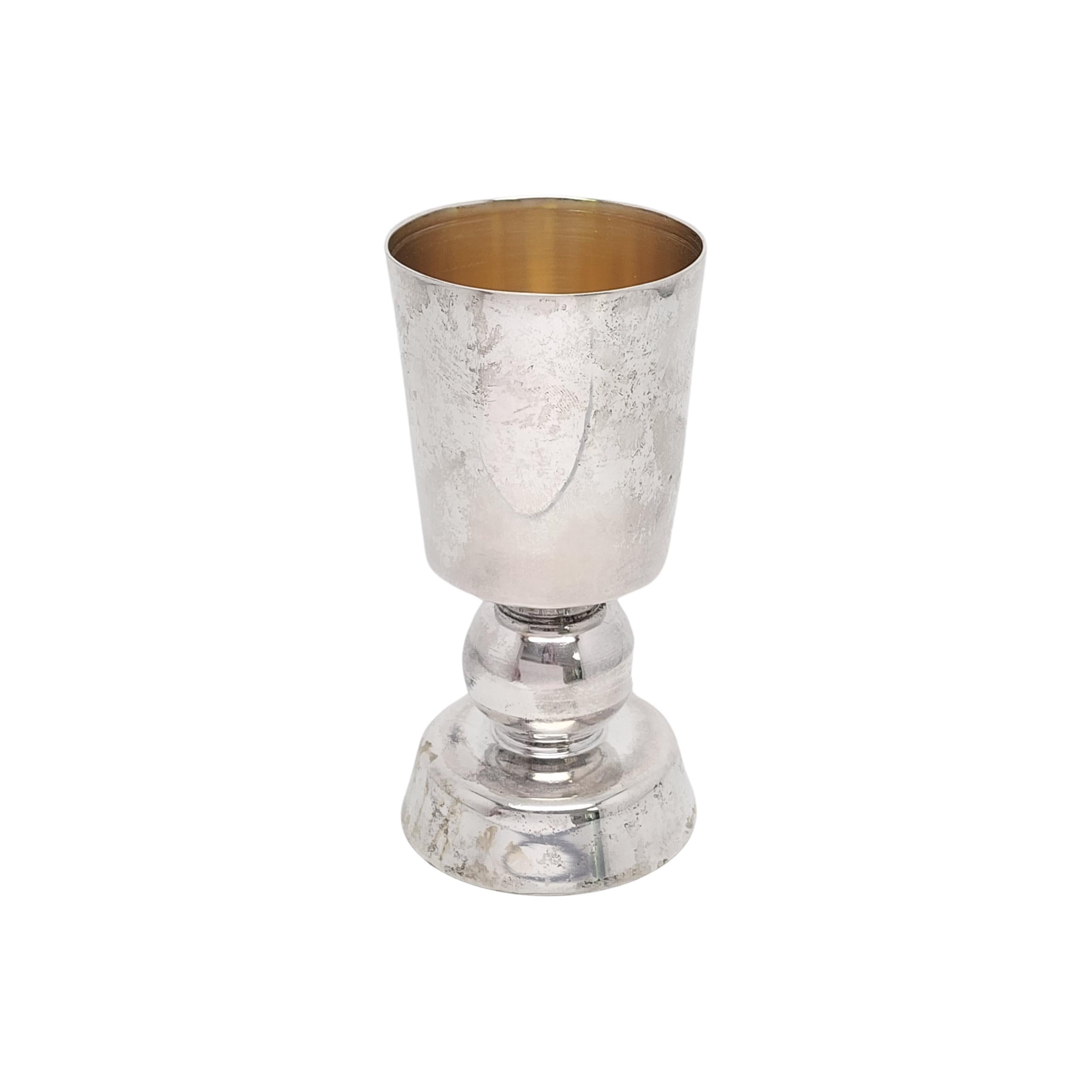 Sterling silver with gold wash interior kiddush cup by Bier Judaica.

A large handmade goblet style kiddush cup with sphere stem by Yitzchak Bier of Bier Judaica.

Measures approx 5 1/8
