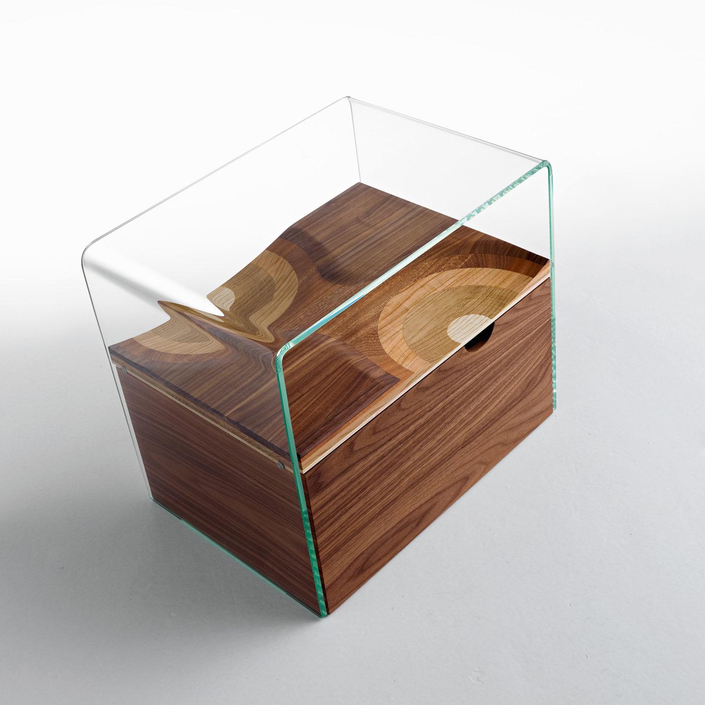 Exquisitely designed by Toyo Ito and part of the Ripples collection, this nightstand features a shelf made of five different types of wood (walnut, cherry, mahogany, ash, and oak), enclosed in an extra clear tempered glass frame, creating a “trompe