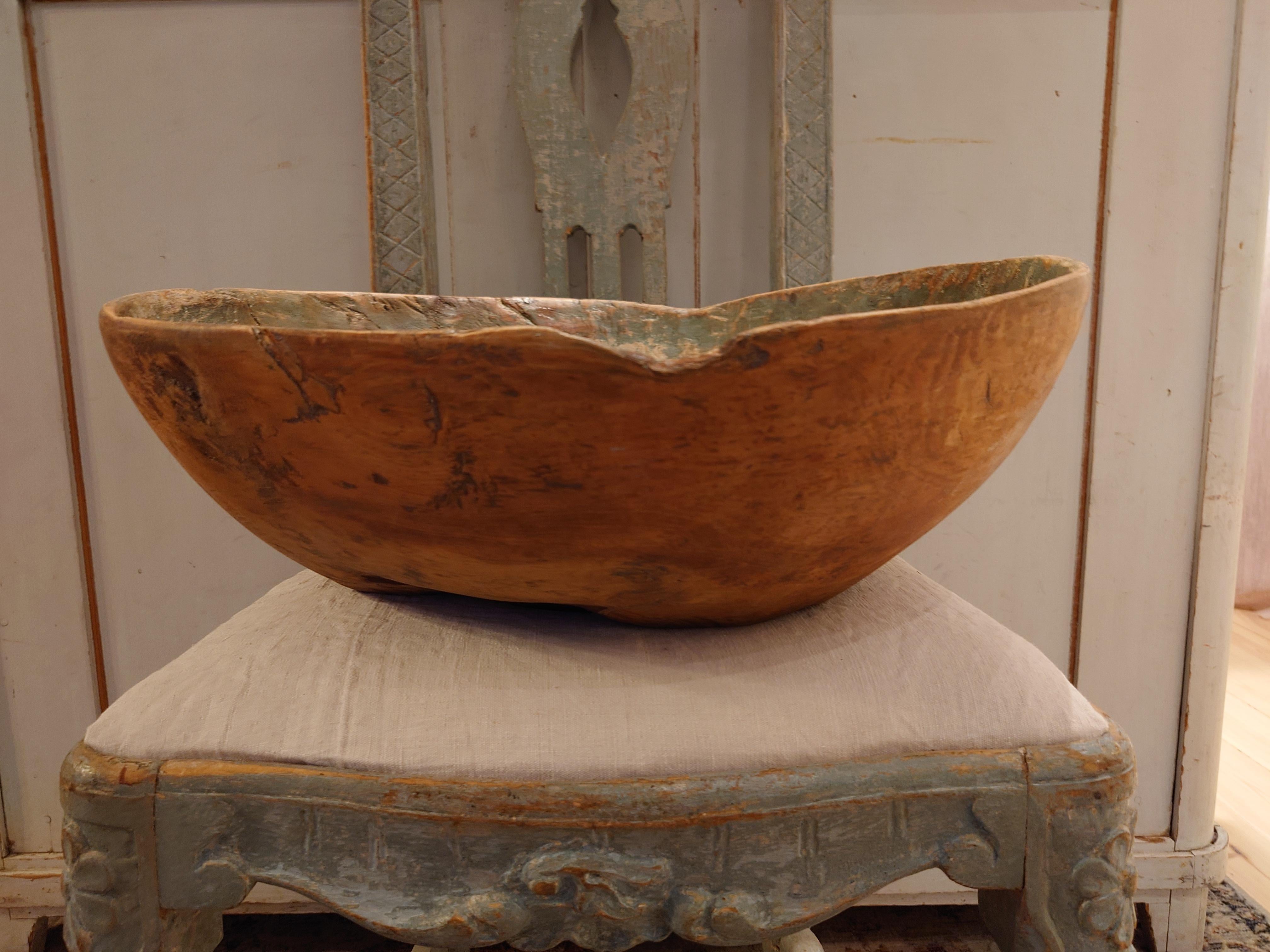   An antique and unique organic wooden bowl. With highly appealing patina, with traces of use. Produced in Sweden,  early 19th century.
The bowl has original paint inside
Beautiful in any room,a real centerpiece.
These bowls where very important for