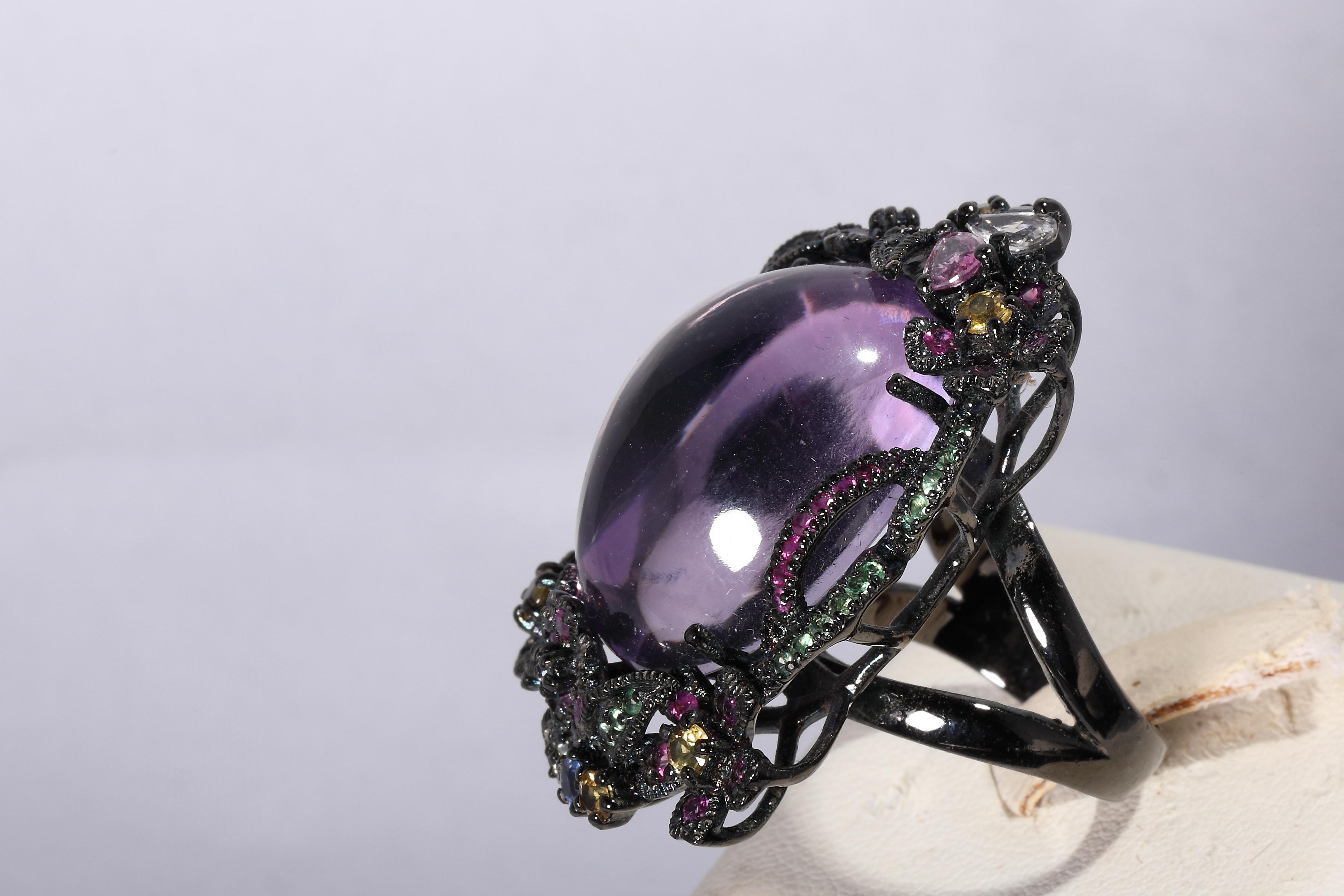 Blackened silver
hallmarked with fineness 925
set with a large amethyst cabochon and colorful sapphires
size ca 40 x 25 mm on top
ringsize 55
weight 25 gram
