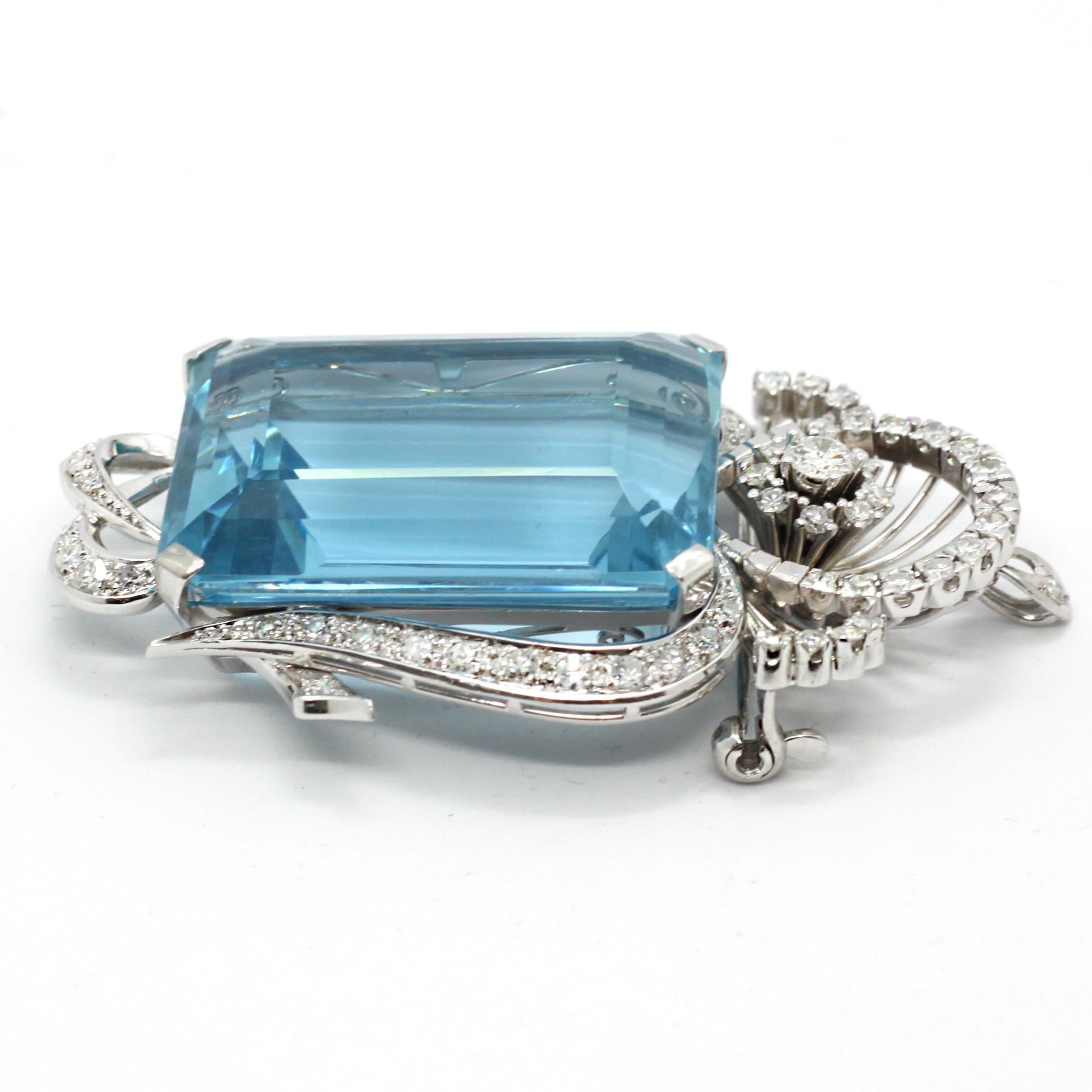 An impressive aquamarine and diamond pendant in platinum, 1960s. The rectangular aquamarine has a beautiful blue colour and weighs circa 80 carats. It is surround by round diamonds with the design embracing the important aquamarine. This item can be