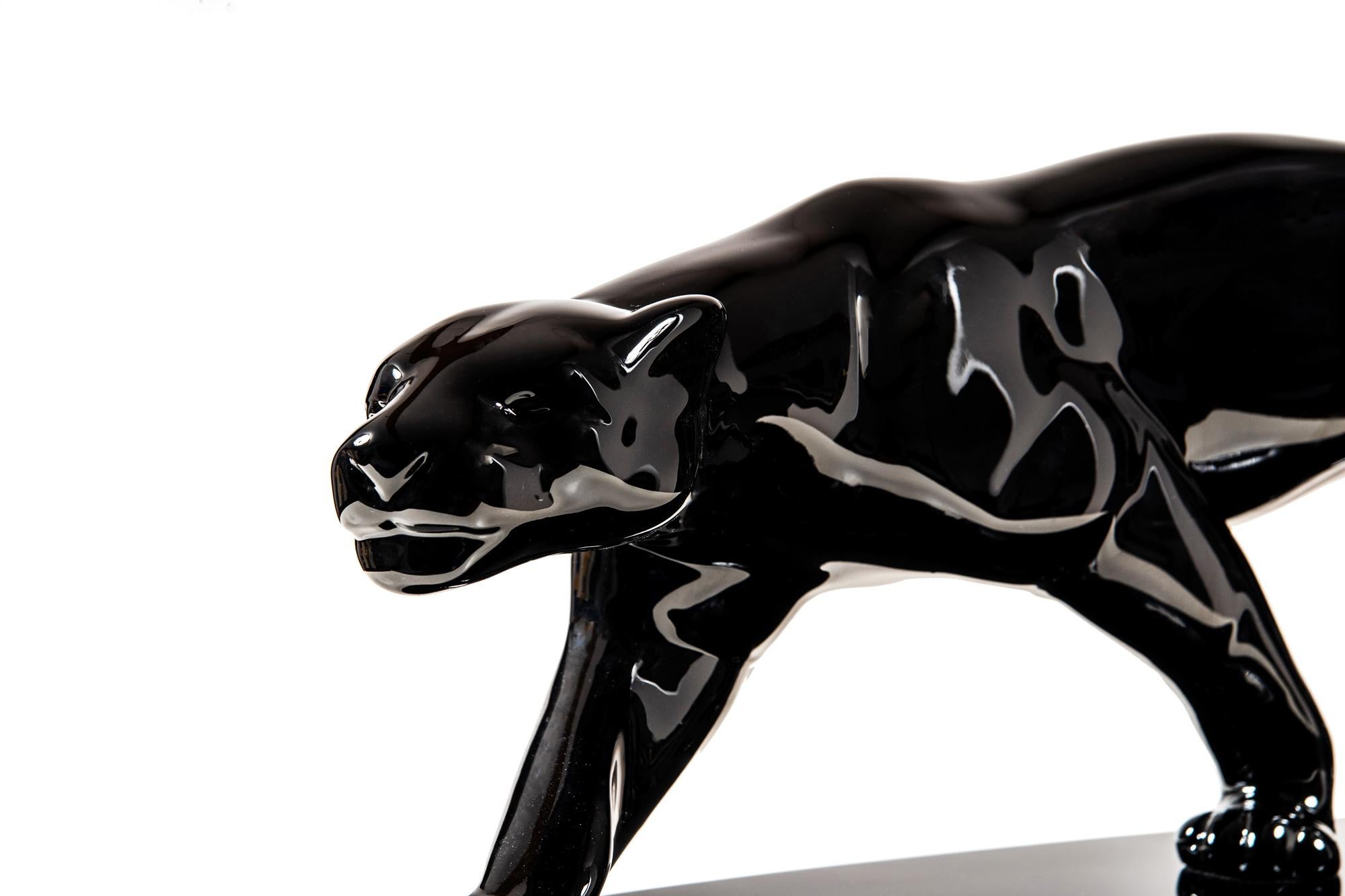 Very big, original panther sculpture from Paris, circa 1940.

Ceramic mass on oval wooden base.
Piano lacquer coated and polished.
Polished (lasercut) stainless steel plate under the base.
Model after Salvatore Melani (1902-1934), who was