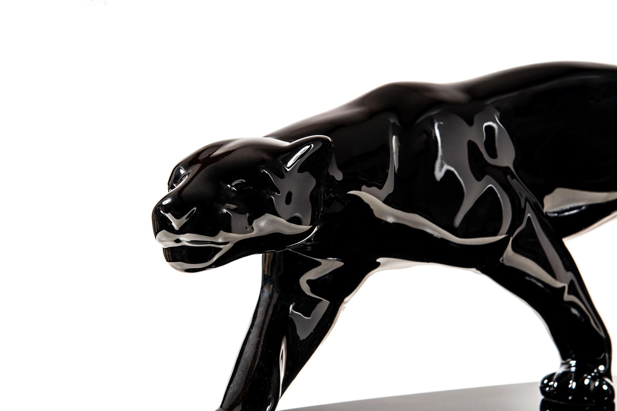 Large original panther sculpture from Paris, circa 1940. In the style of Paul Jouve's Panther drawing.

Ceramic mass, polyester lacquer coated and polished.
Polished (lasercut) stainless steel plate under a lacquered oval wooden base.
Model