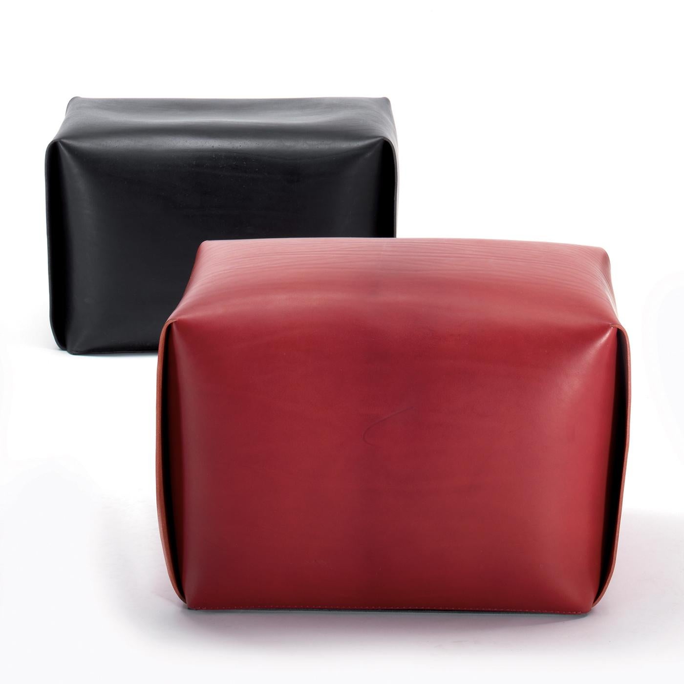 Part of the Bao collection of ottomans, this striking red leather piece will make a statement in any modern interior, adding a pop of color to any living room or study. The softness of the frosted leather covers a comfortable interior made of