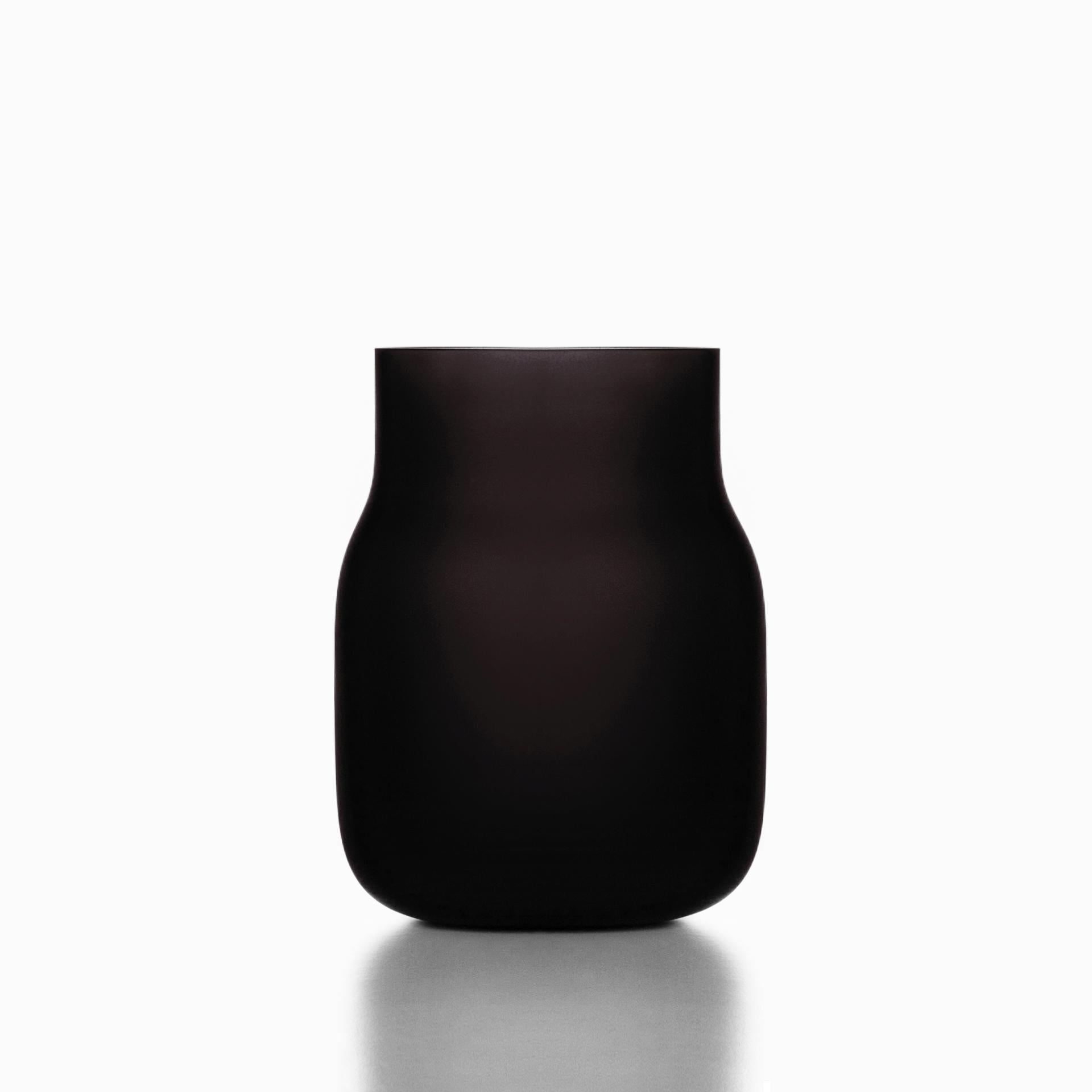 Big black Bandaska matte vase by Dechem Studio.
Dimensions: D 18 x H 24 cm.
Materials: glass.
Available in 4 sizes: D15 x H25/ D18 x H24/ D9 x W31/ D22 x H33 cm.
Available in black, uranium yellow, dark blue.

Hand-blown into beech wood mold,