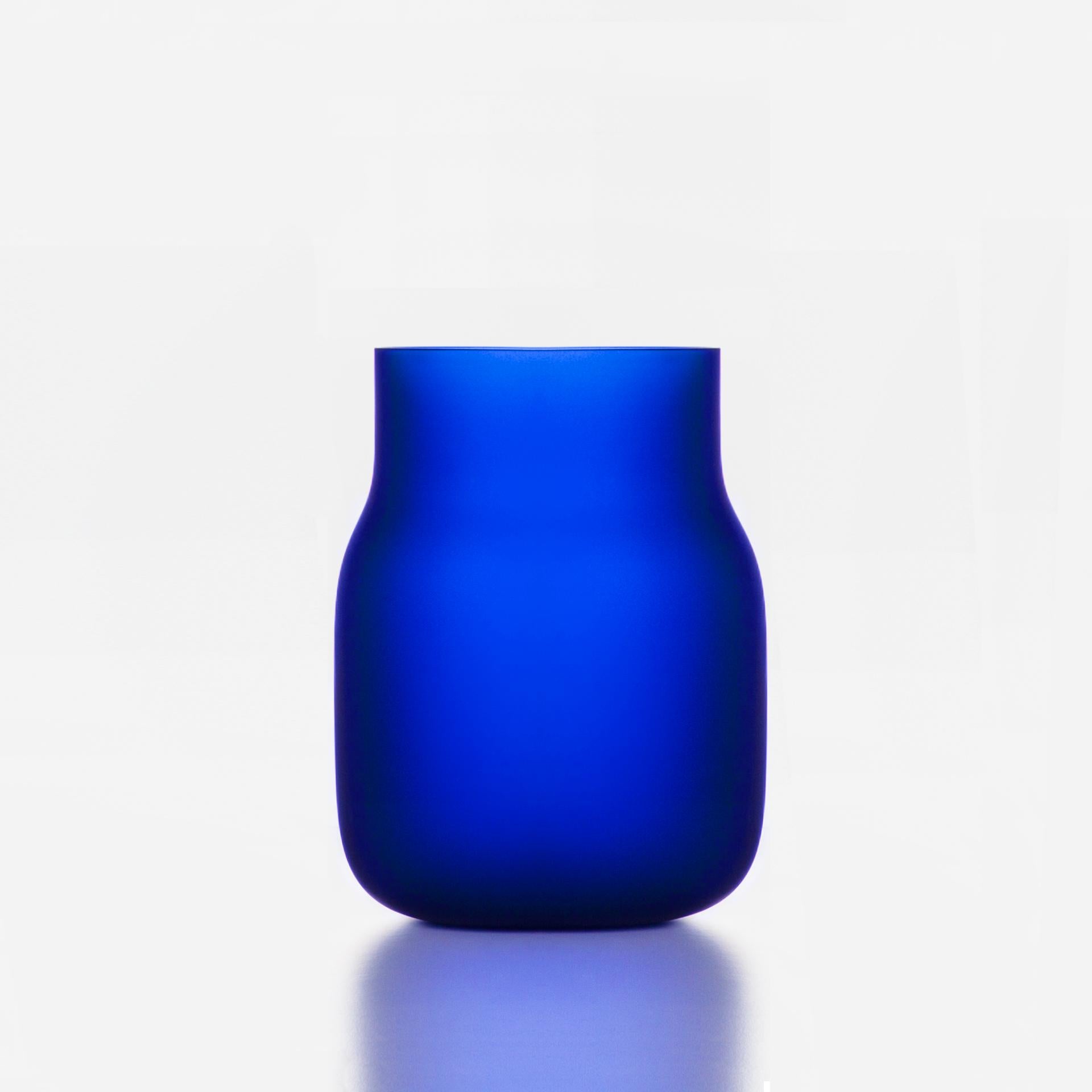 Big Blue Bandaska Matte vase by Dechem Studio.
Dimensions: D 18 x H 24 cm.
Materials: glass.
Available in 4 sizes: D15 x H25/ D18 x H24/ D9 x W31/ D22 x H33 cm.
Available in black, uranium yellow, dark blue.

hand blown into beechwood mold,