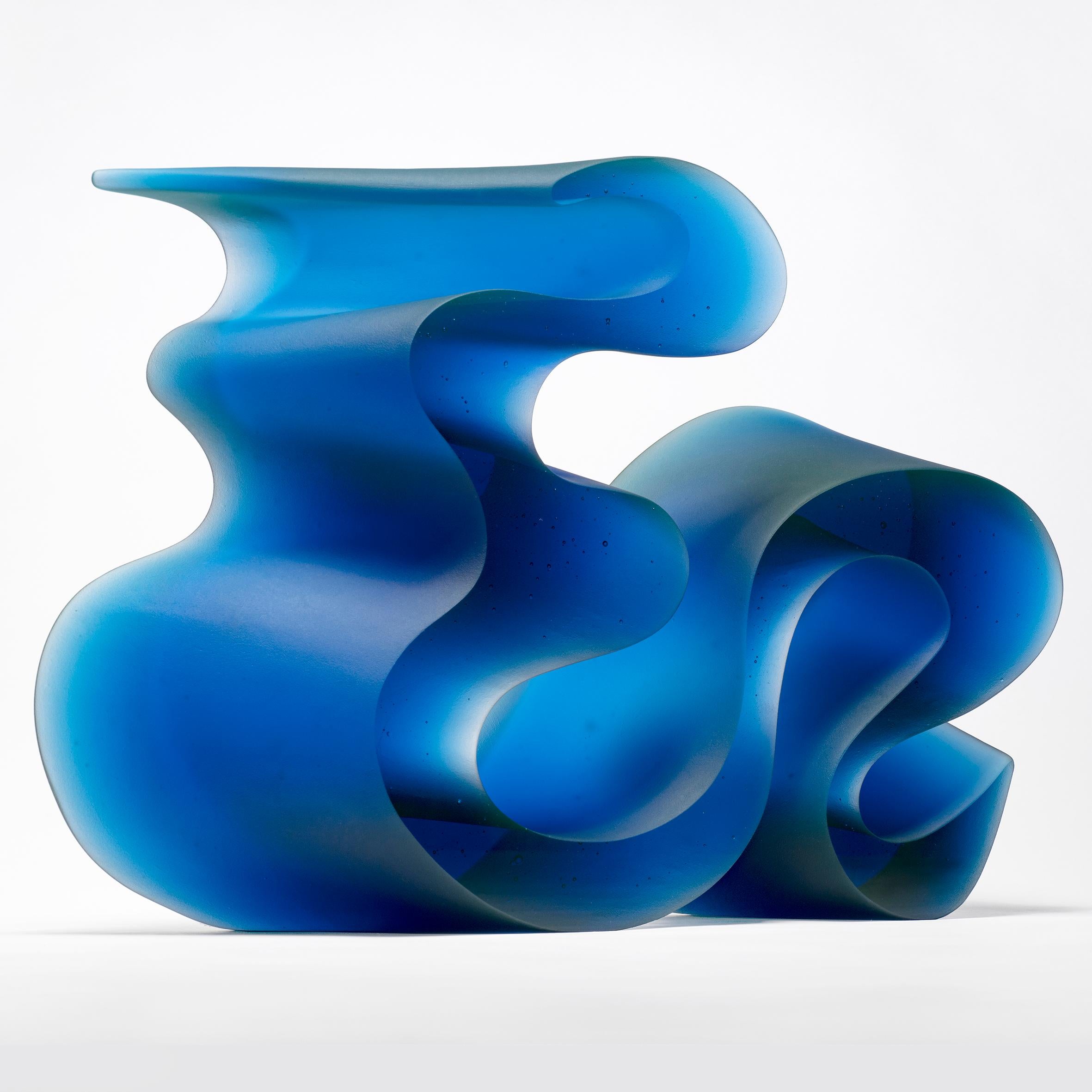 Big blue line is a unique cast glass sculpture in blue glass, created by the Danish artist Karin Mørch. Dramatic sweeping curves Meander and follow the beautiful lines of this heavy and solid cast piece. Mørch intimately understands her glass and