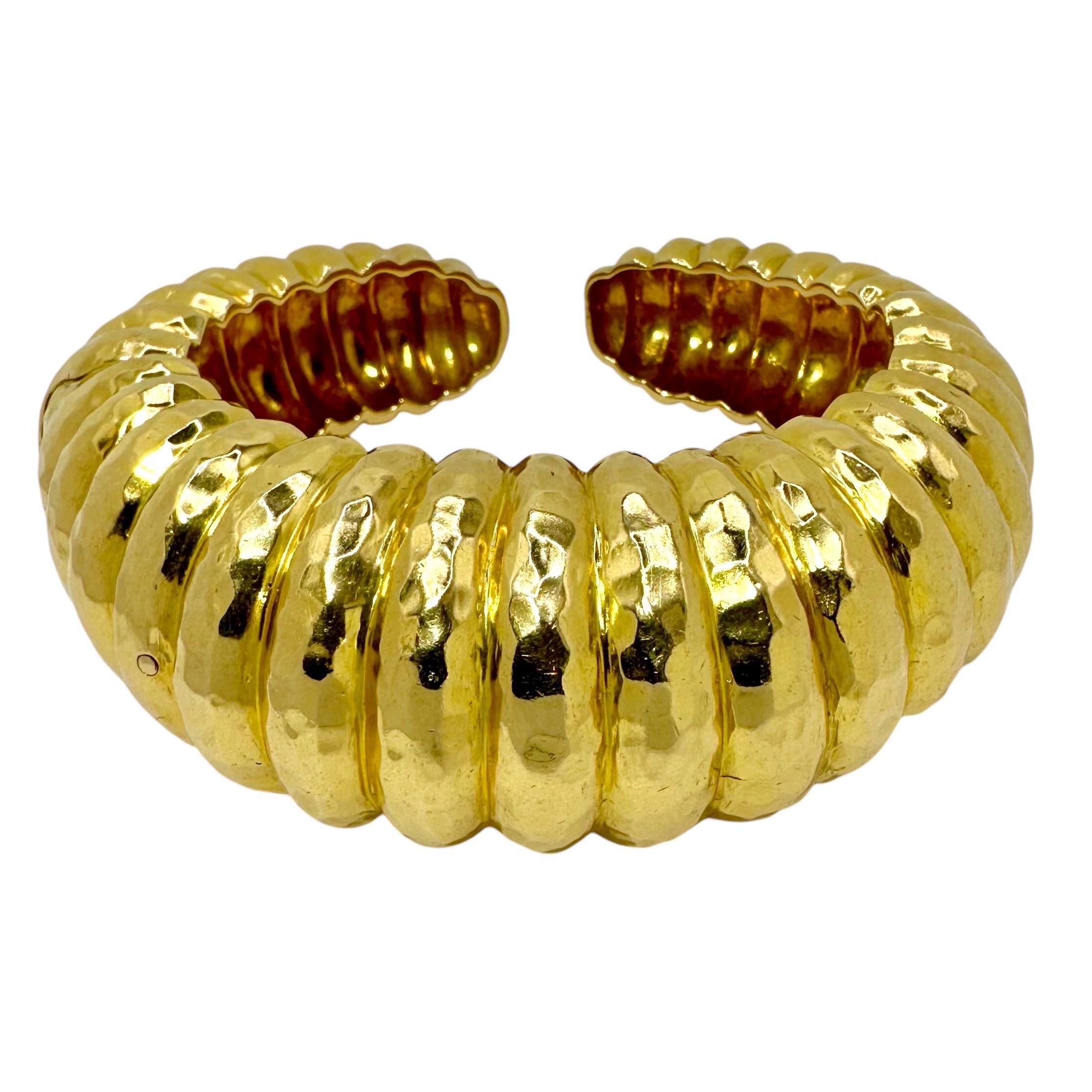 Ce bracelet bombe vintage en finition martelée est assez grand, mesurant plus d'un pouce de largeur au centre à l'avant et se rétrécissant à un peu moins d'un demi-pouce à l'arrière. Lorsqu'il est porté, il dépasse le poignet d'un demi-pouce à