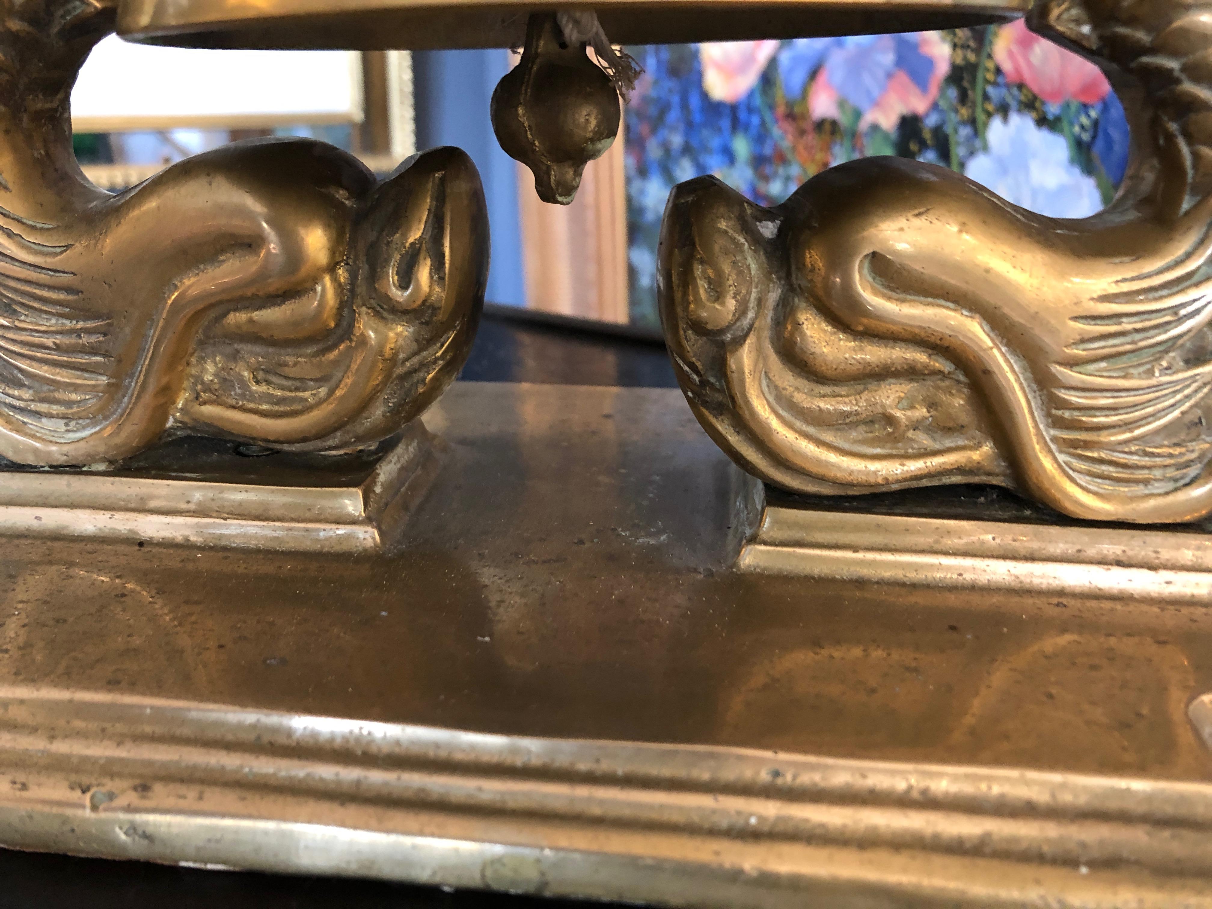 A wonderful vintage nautical big brass bell with dolphins on each side.